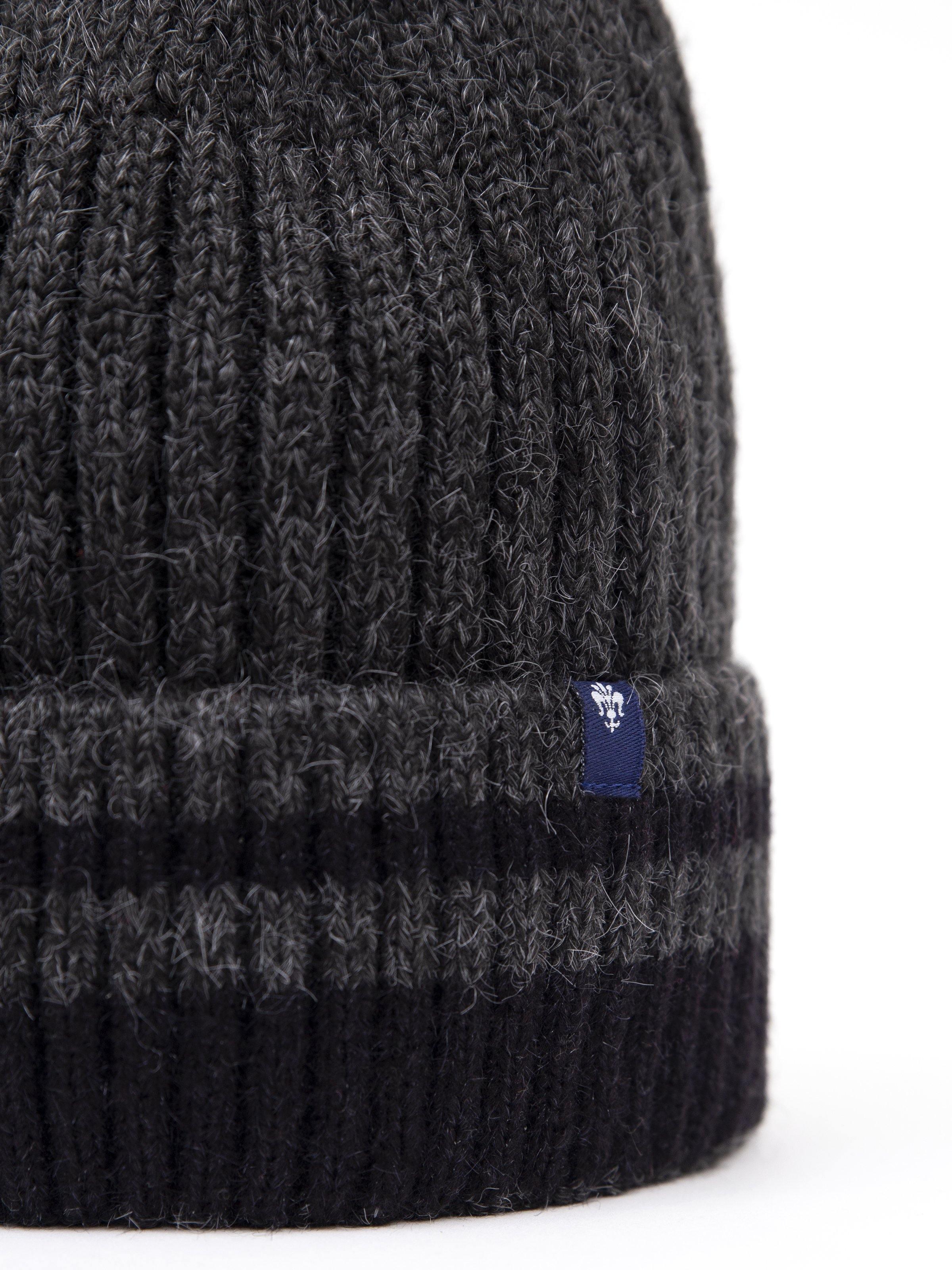 Wool cap beanie with ribbed knit texture and blue logo patch on cuff