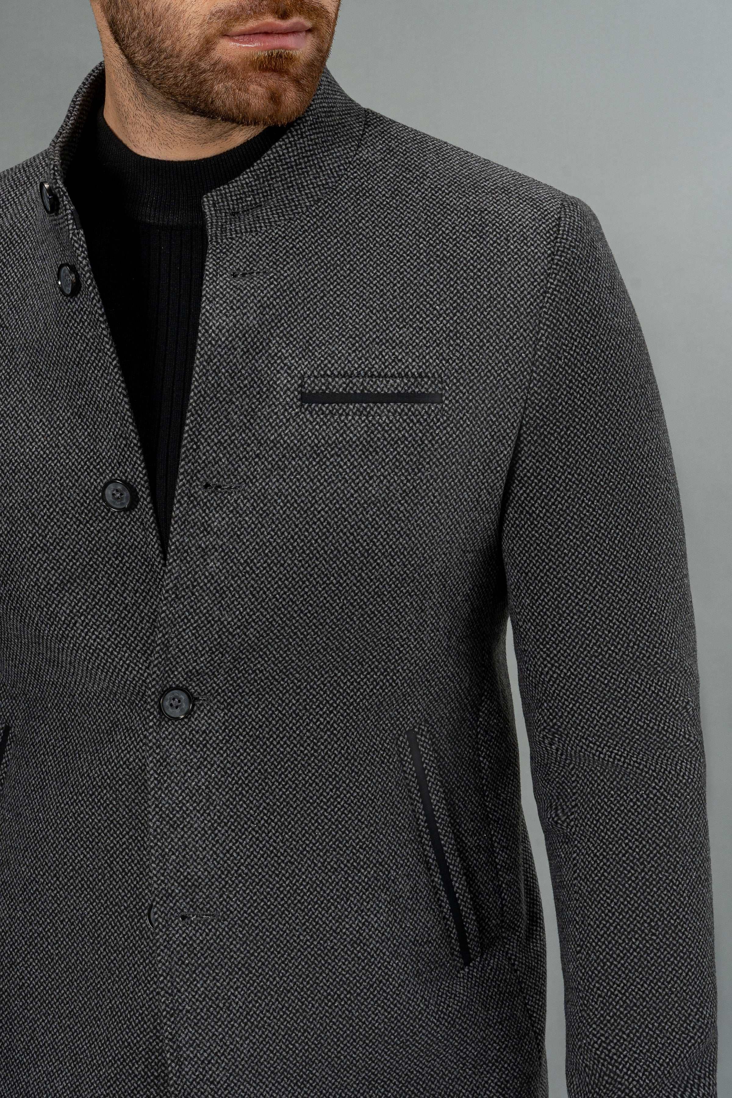 Dark gray wool casual coat close-up of textured fabric and chest pocket
