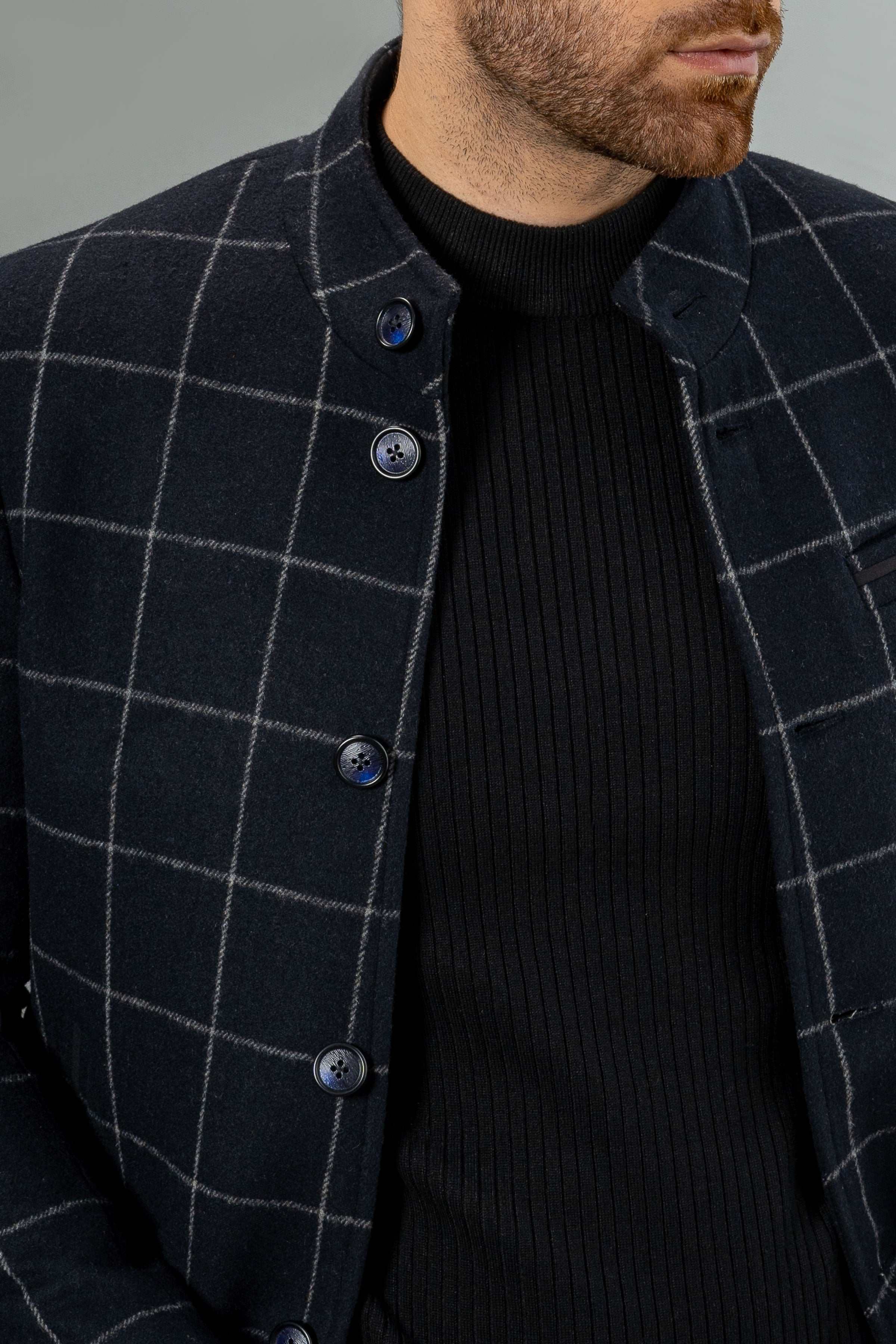 Navy checked wool coat close-up with button front and stand collar