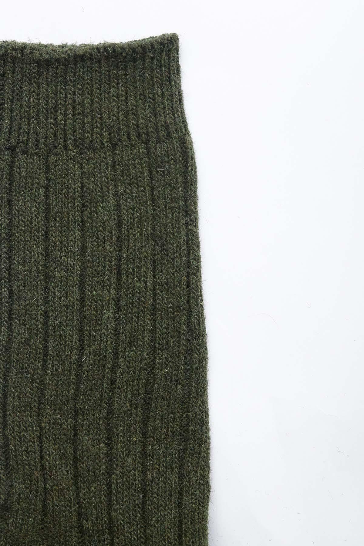 Dark green ribbed woolen sock cuff and knit pattern detail