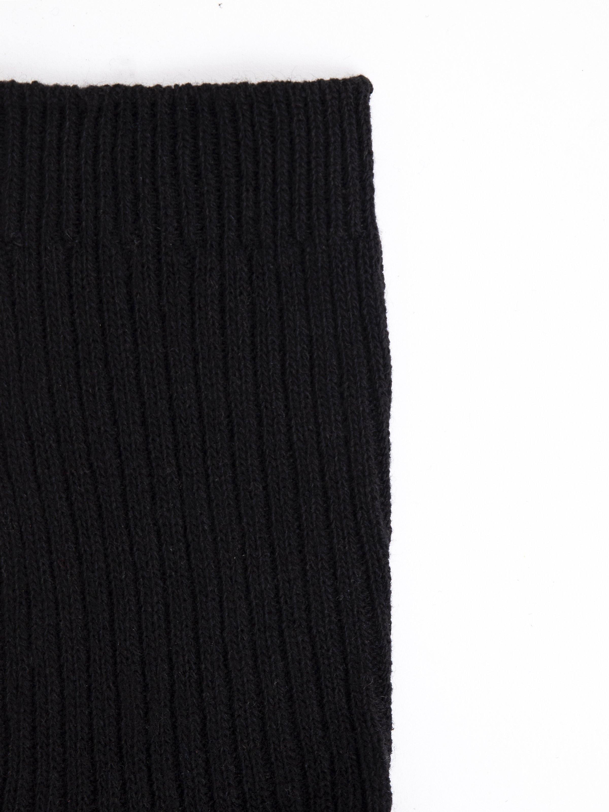 Woolen sock fabric close-up, dark ribbed knit texture