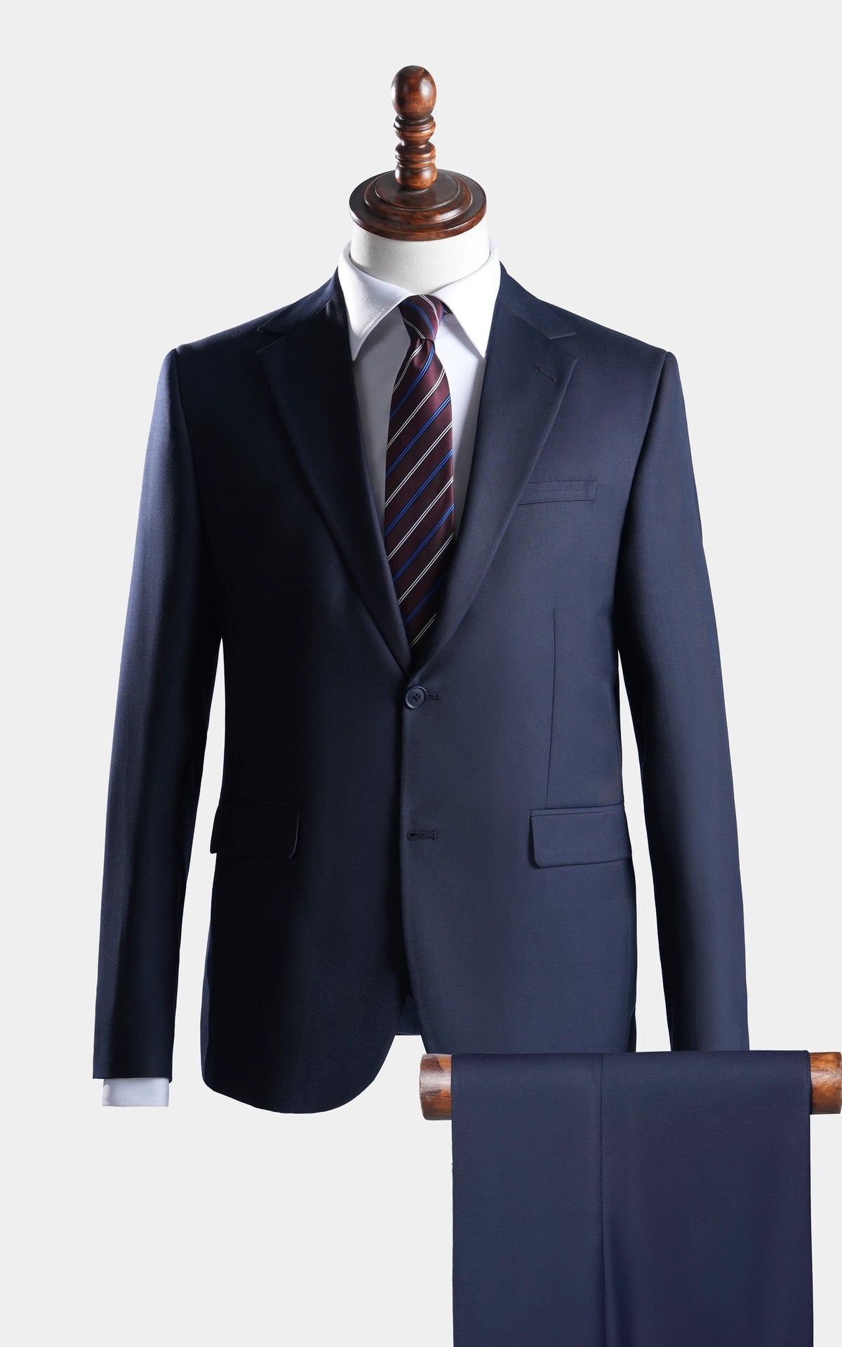 Navy two-piece suit: notch-lapel blazer with matching trousers, on a mannequin