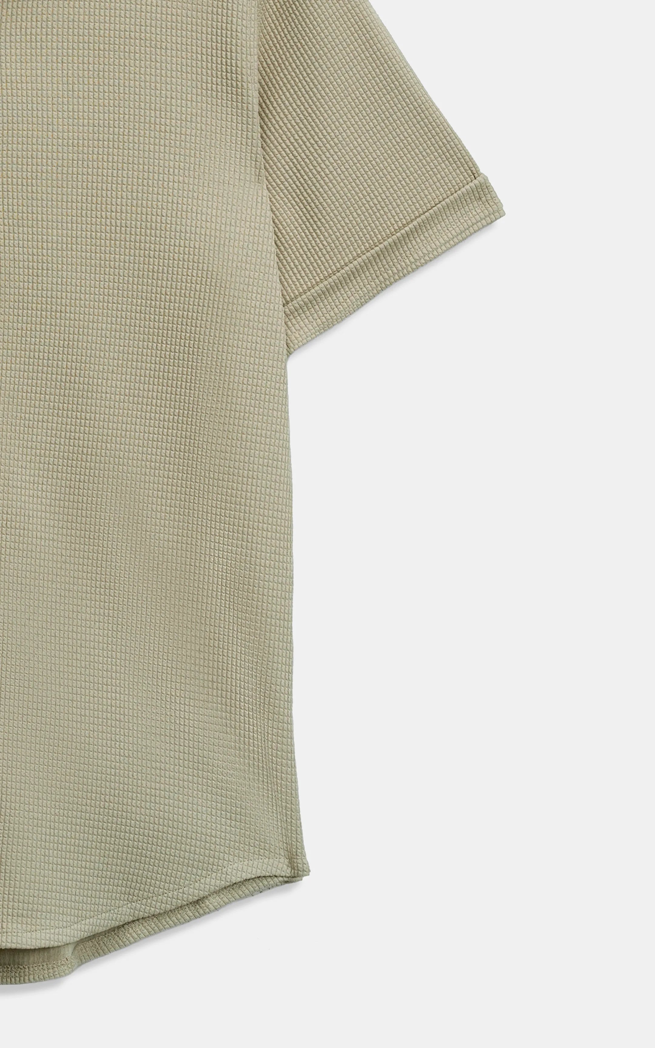 Khaki self-textured shirt fabric close-up with short-sleeve cuff