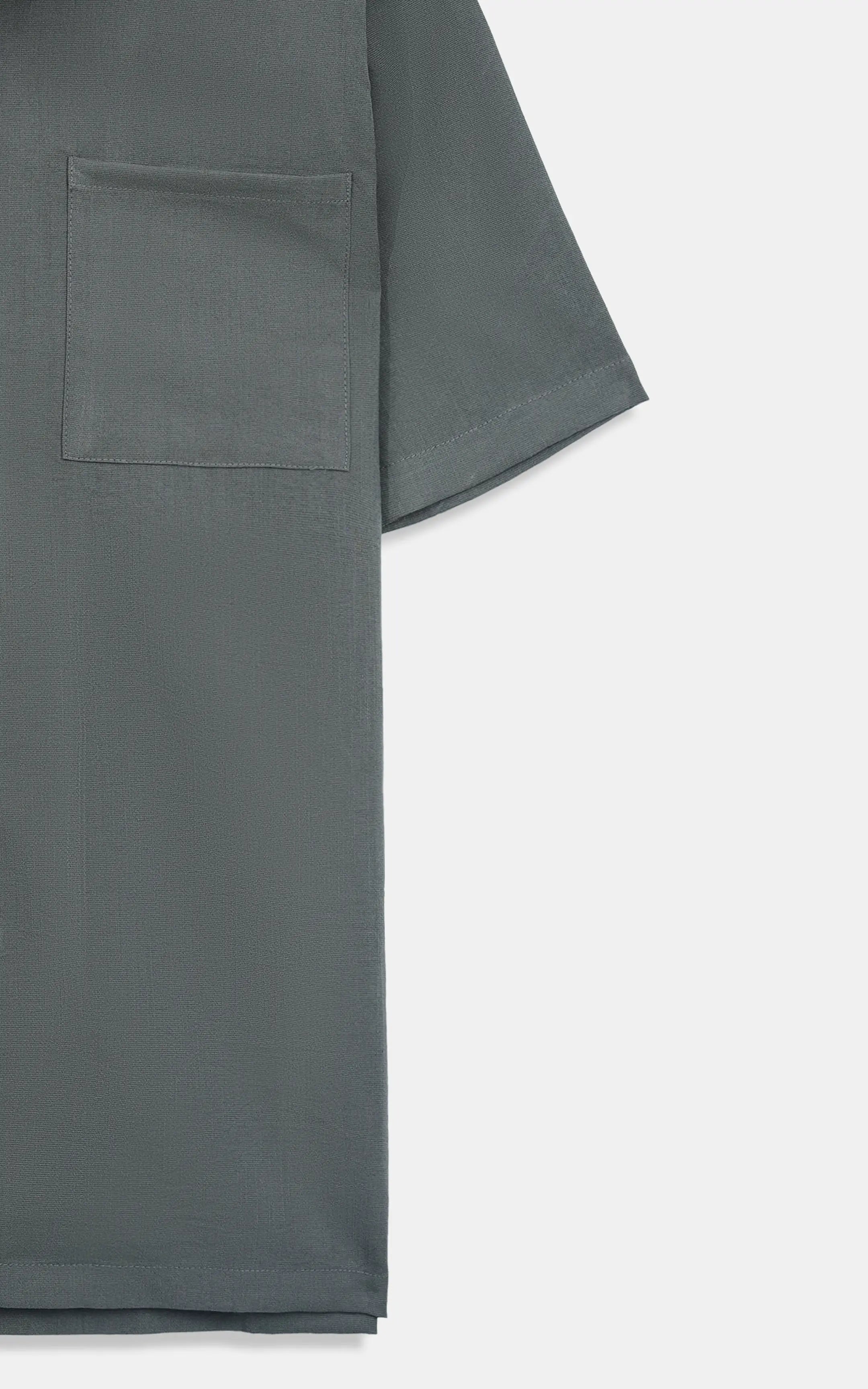 Dark grey casual shirt fabric close-up, chest pocket and curved hem