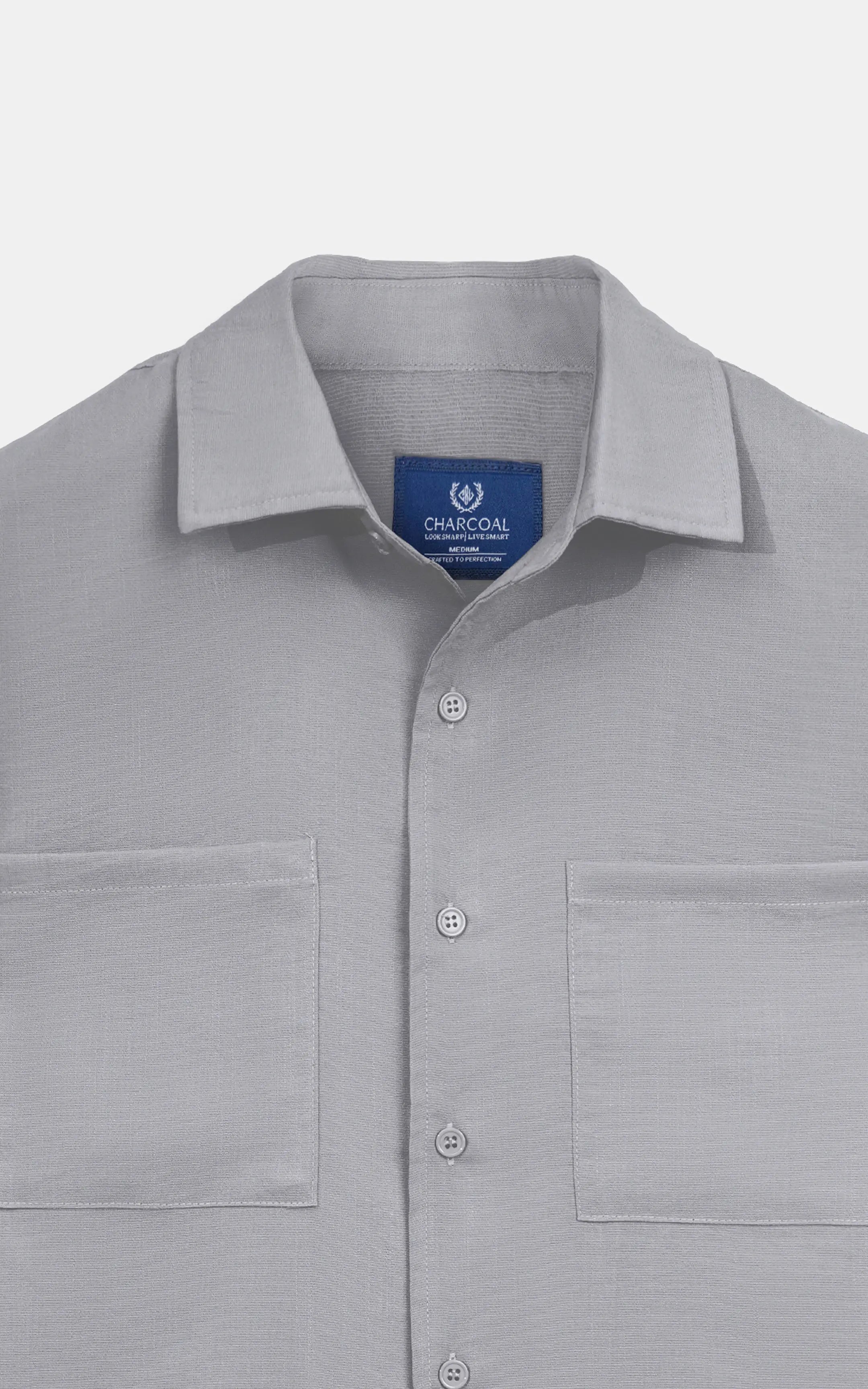 Light grey shirt collar close-up with button placket and brand label