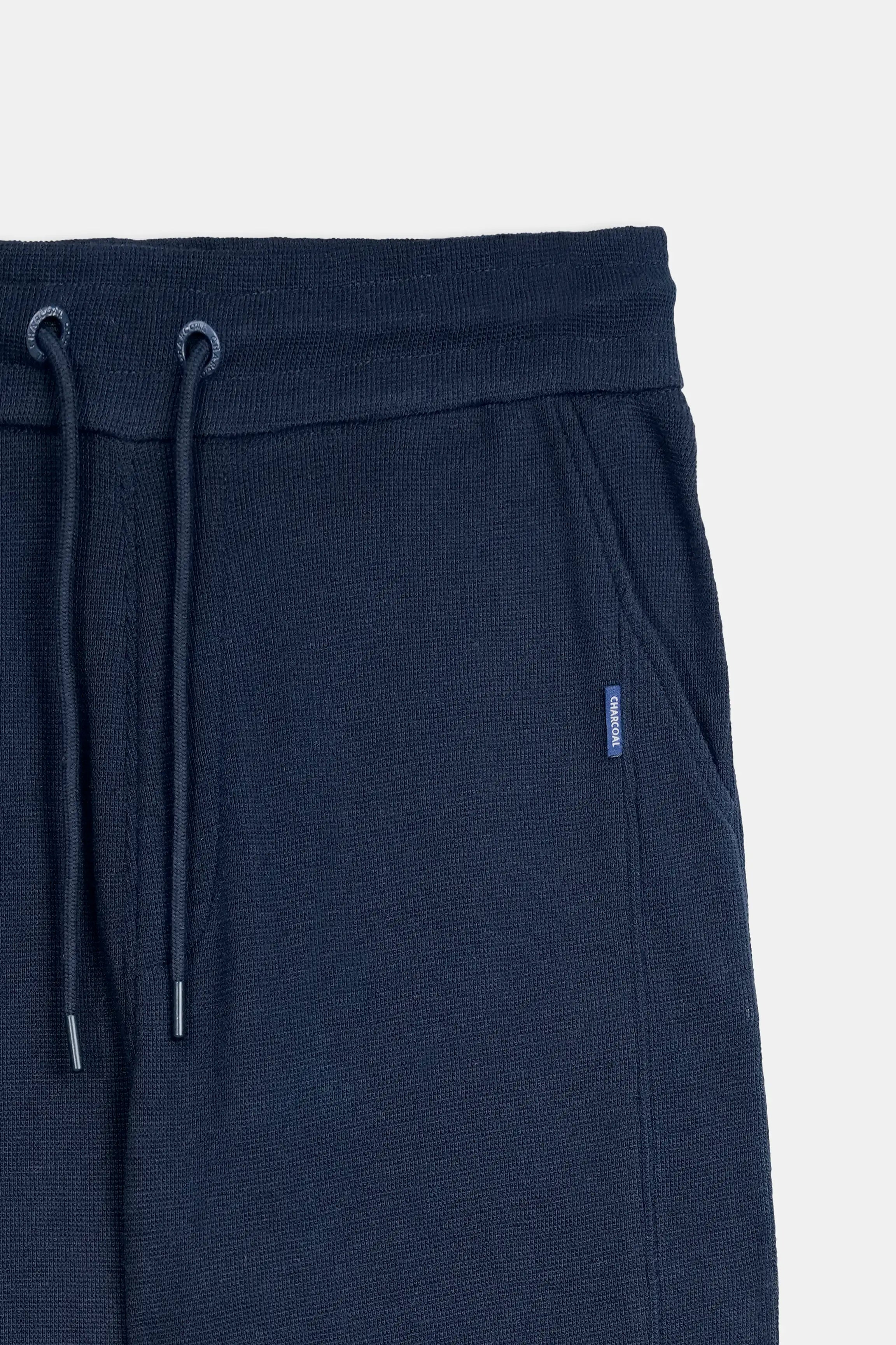 Navy knit trousers waistband with drawstring and small logo patch