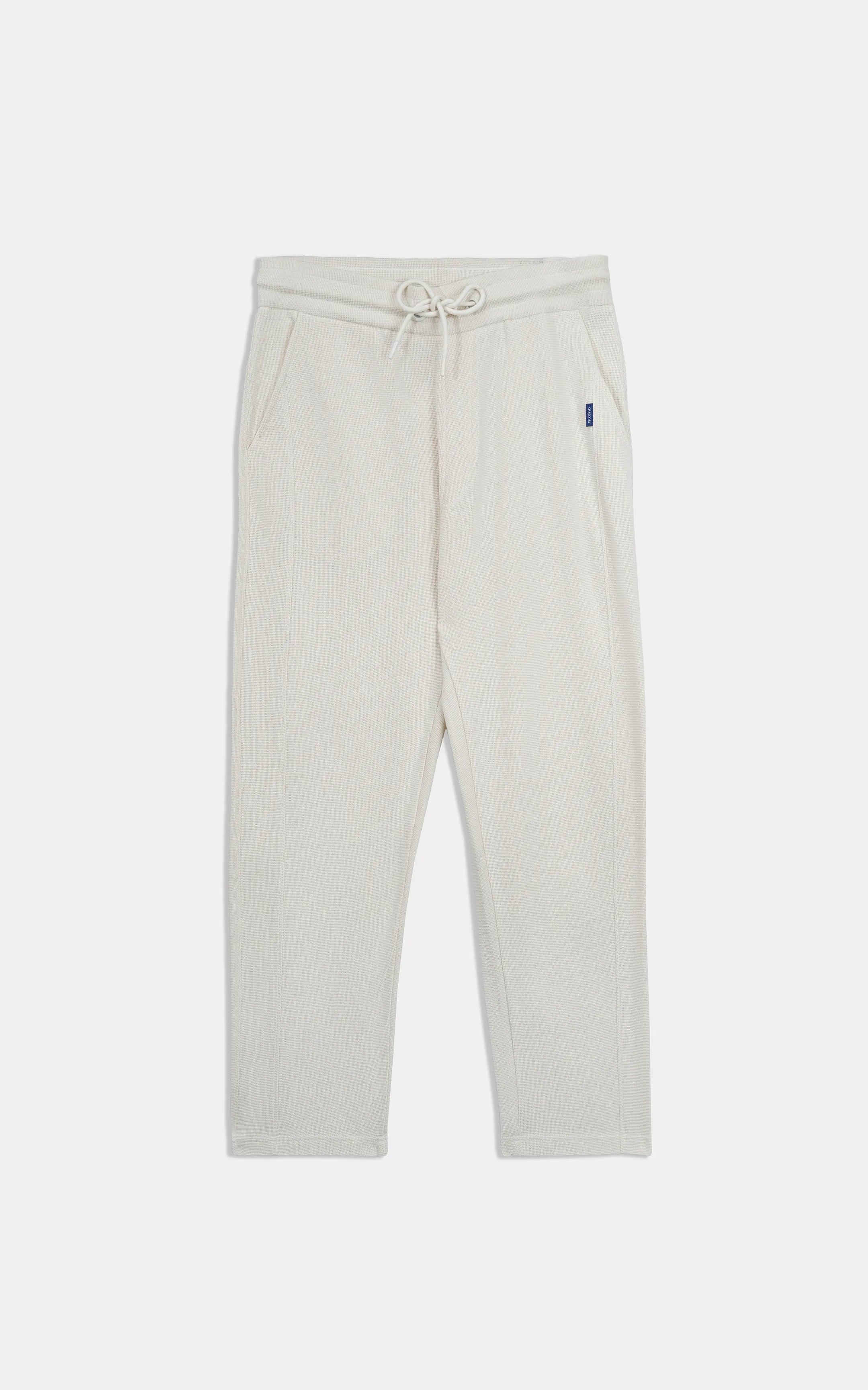 Off-white knit drawstring trousers with ribbed ankle cuffs