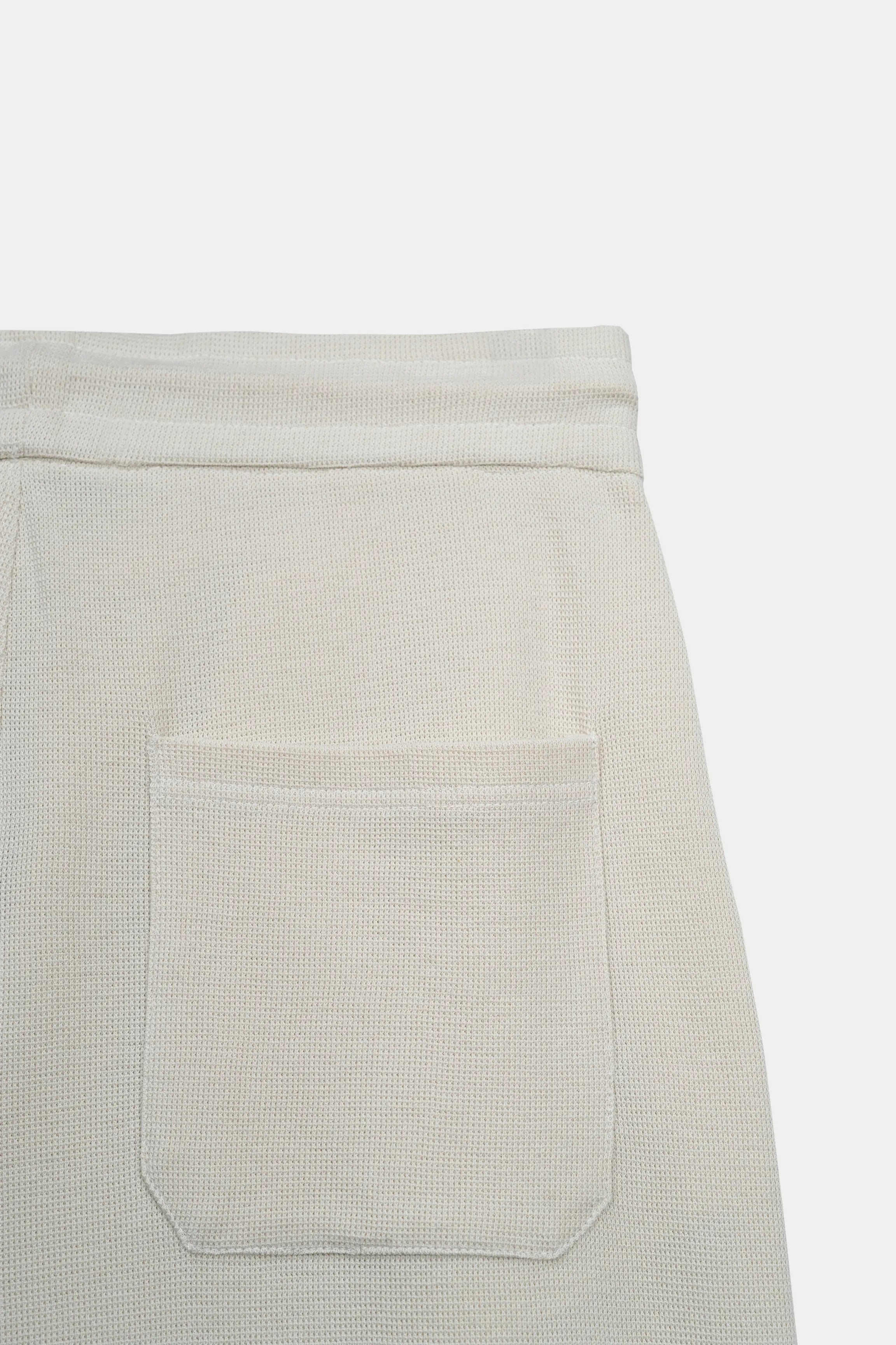 Off-white knit trouser with front patch pocket detail