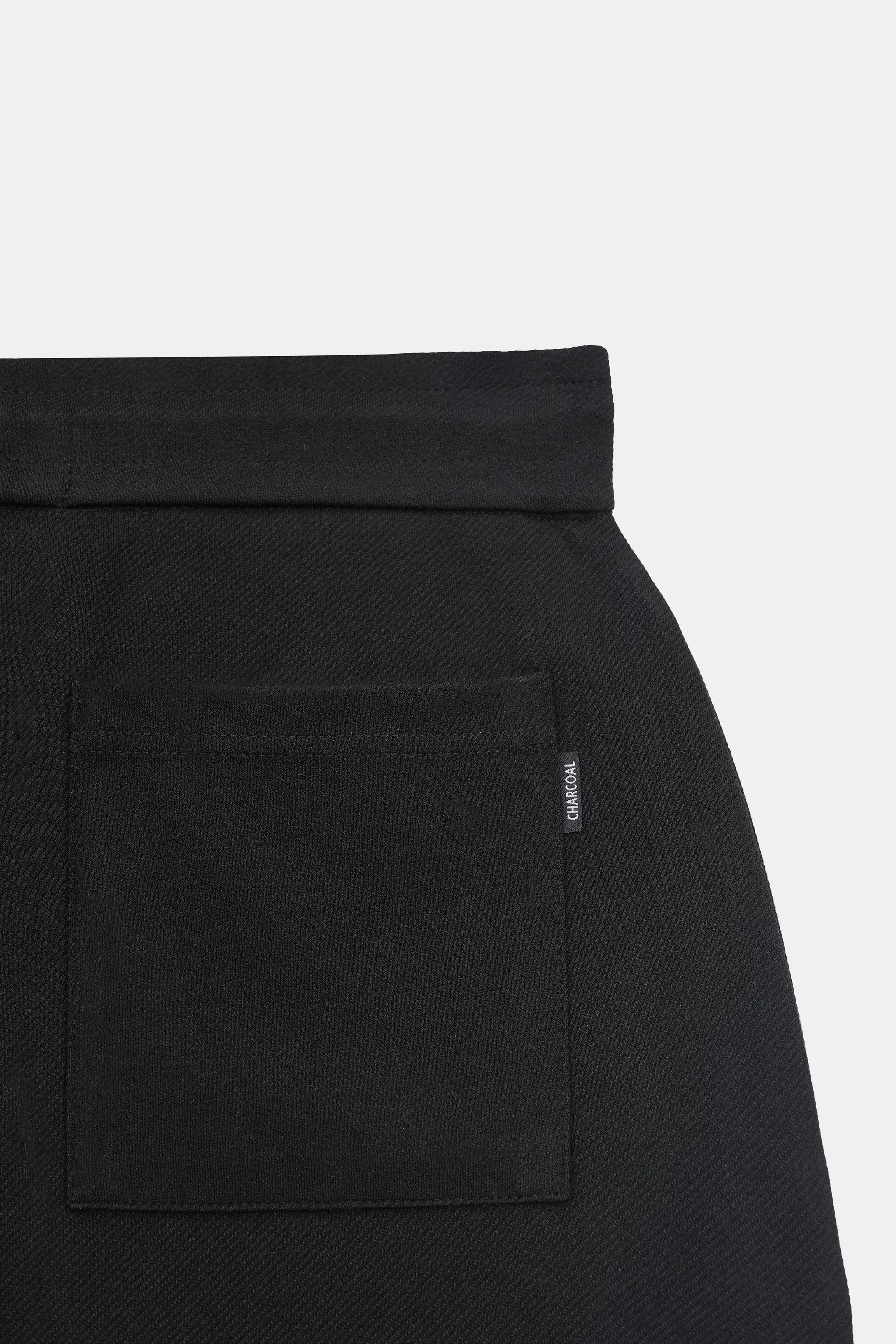 Black shorts with patch pocket and small vertical logo label