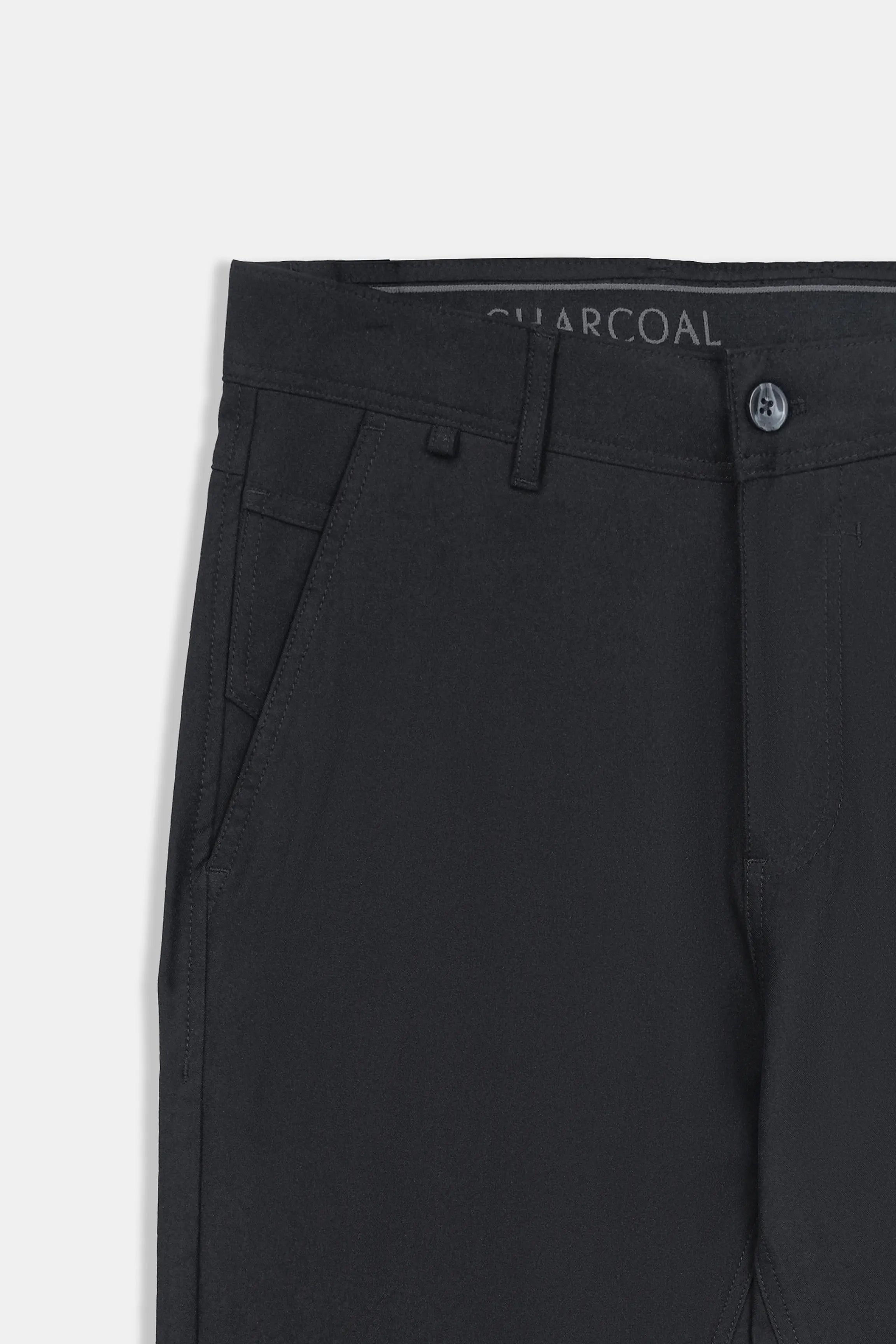 Black waistband of straight-fit travel pants with belt loops and button closure