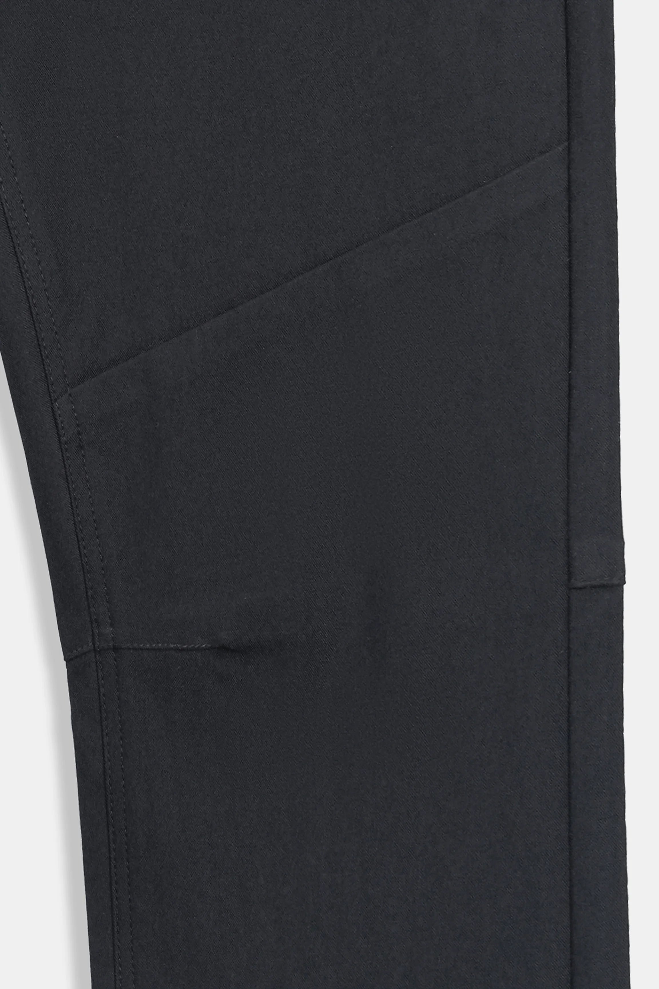 Black travel pants fabric with stitched panel and diagonal seam detail