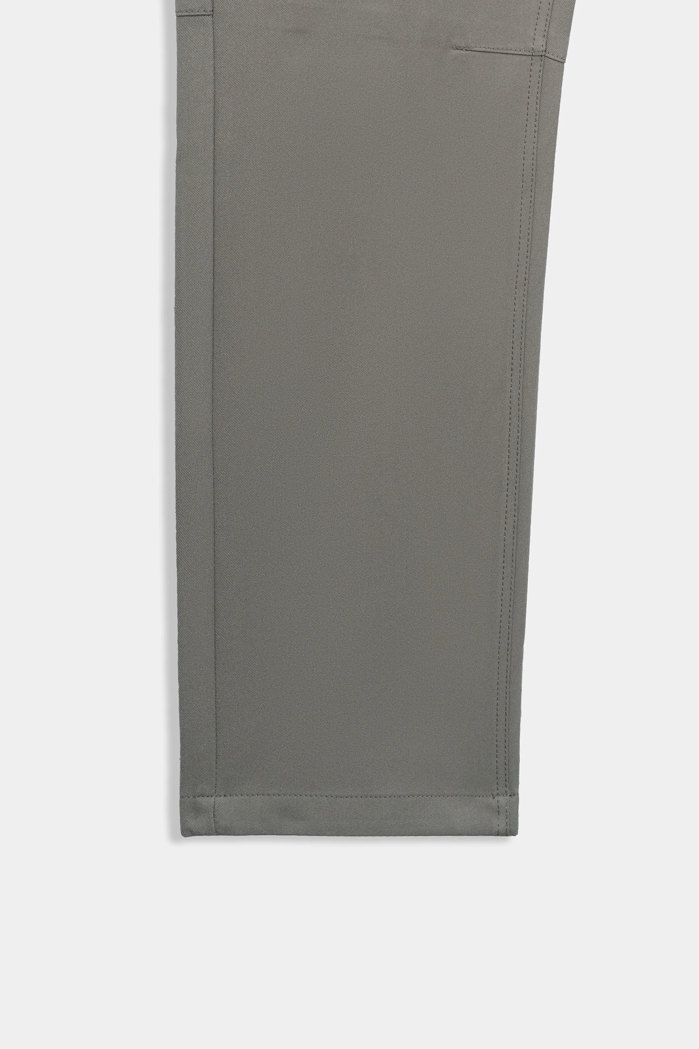 Straight-fit travel pants in light brown, close view of outer fabric and back hem.