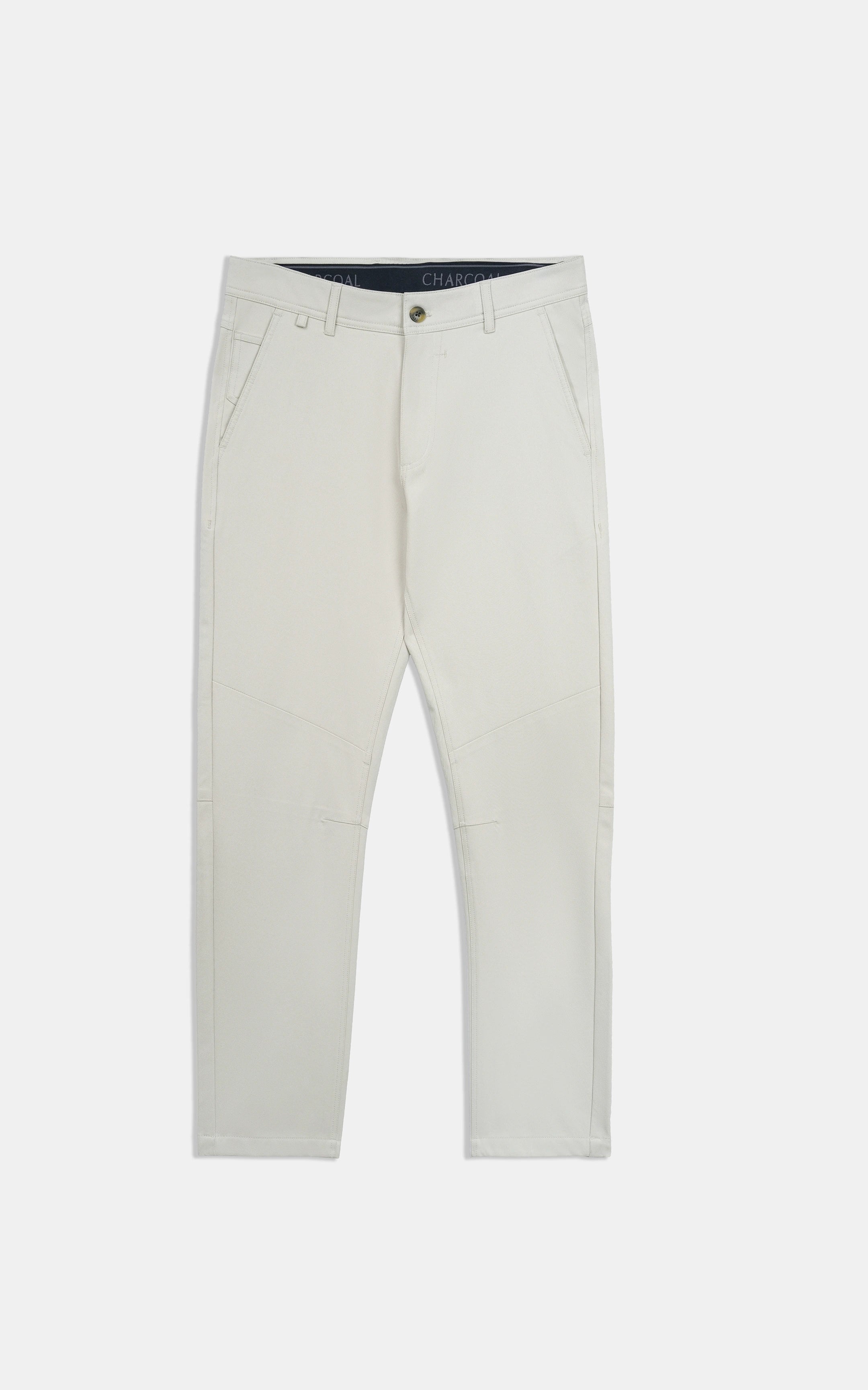 Light beige straight-fit travel pants laid flat, front button closure and belt loops