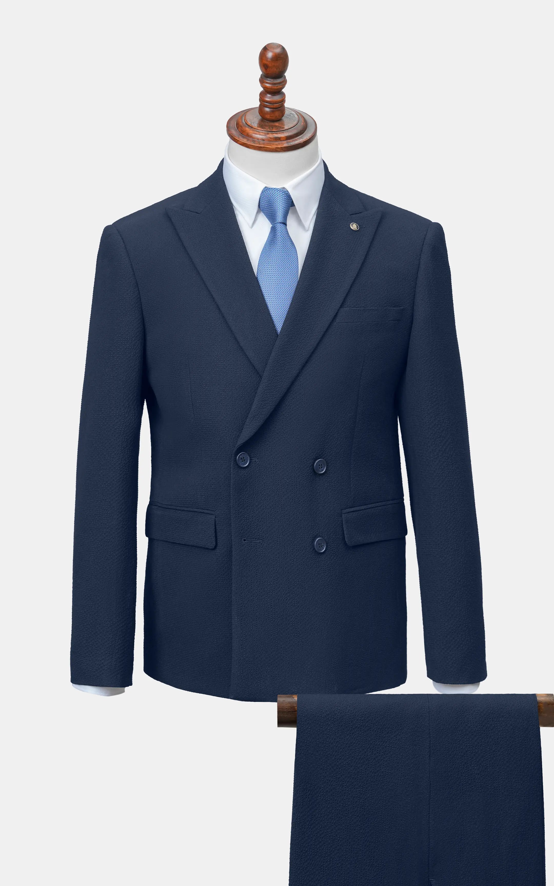 Navy double-breasted suit jacket with matching navy trousers, front view
