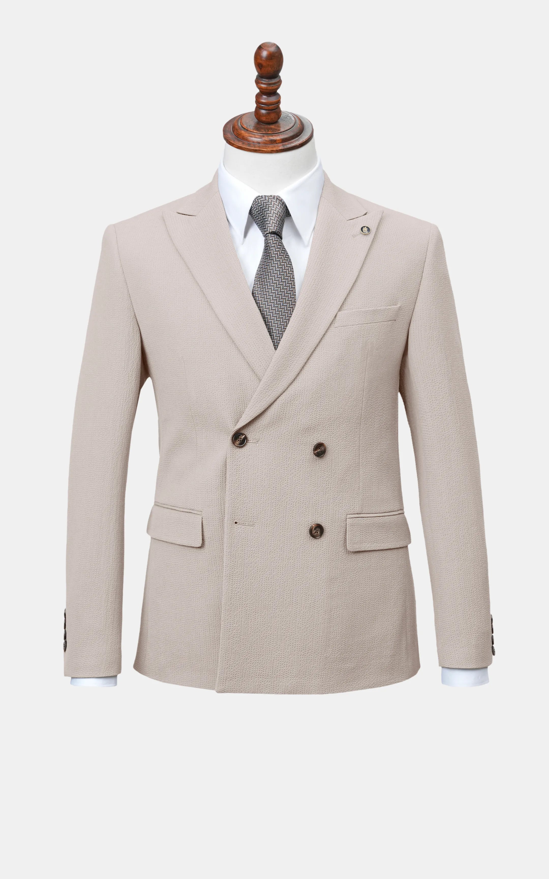 Light brown double-breasted suit jacket with gray patterned tie and white shirt