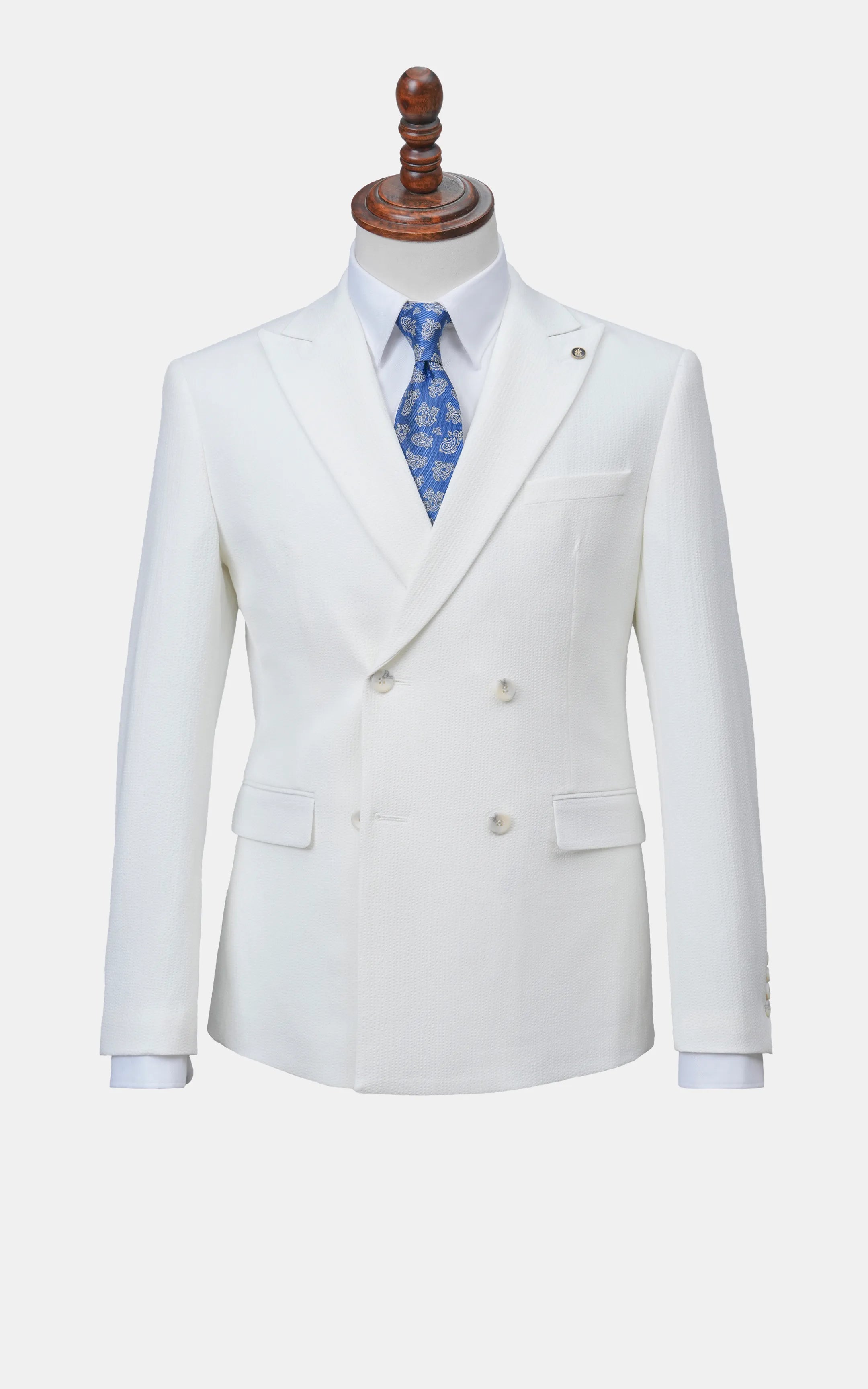 White double-breasted suit jacket on mannequin with blue patterned tie