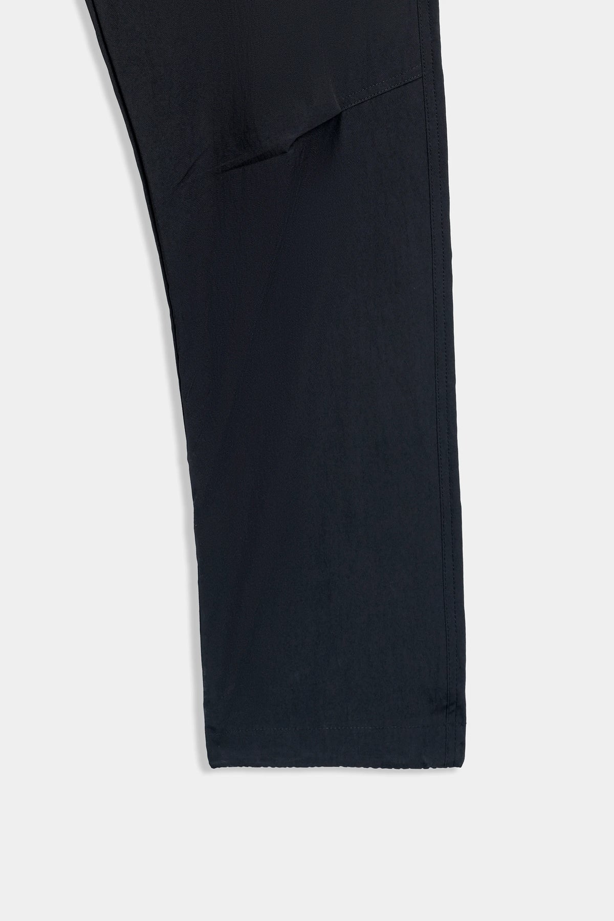 Black trouser leg with stitched hem and side panel seam