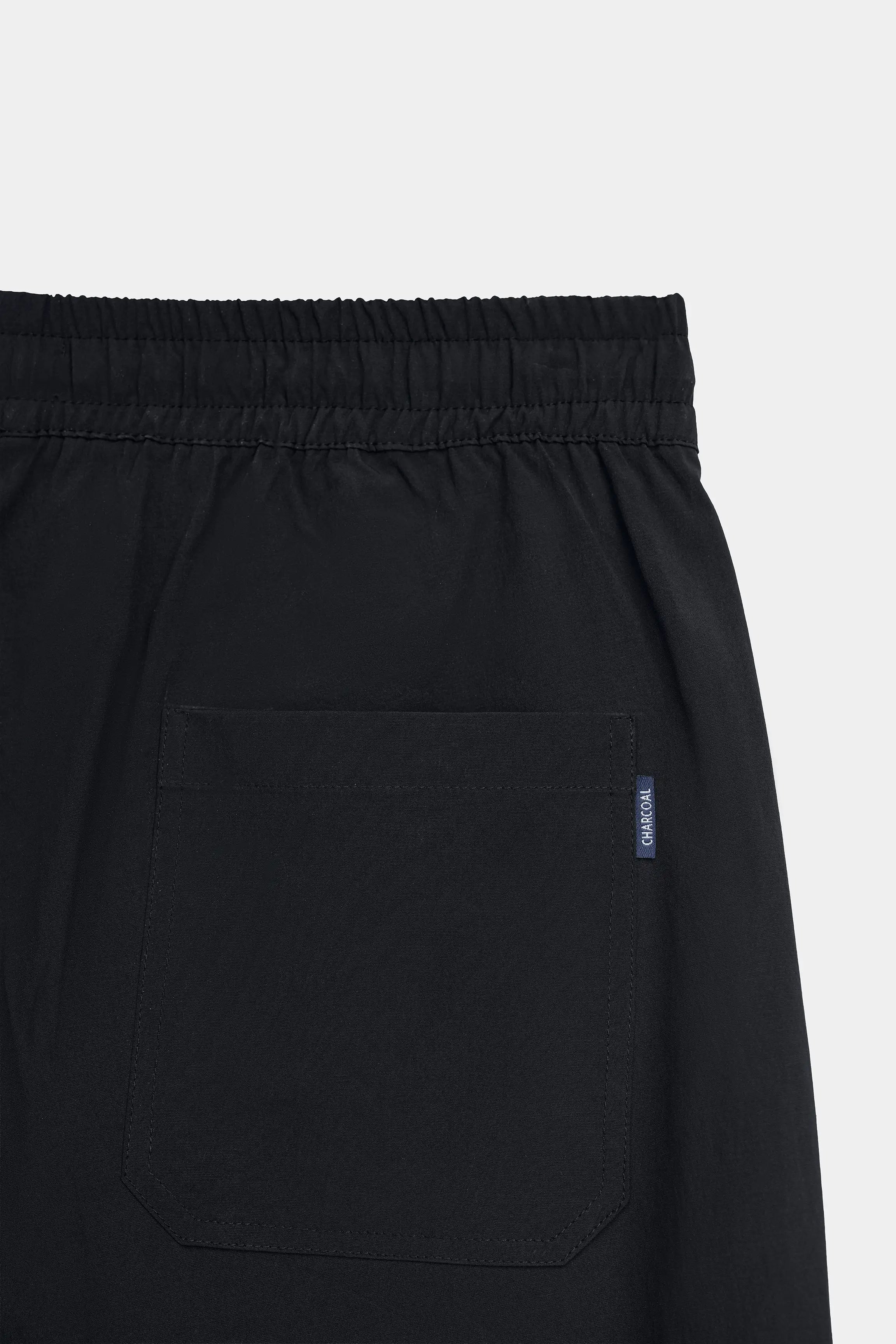 Black trousers with elastic waistband and front side pocket detail
