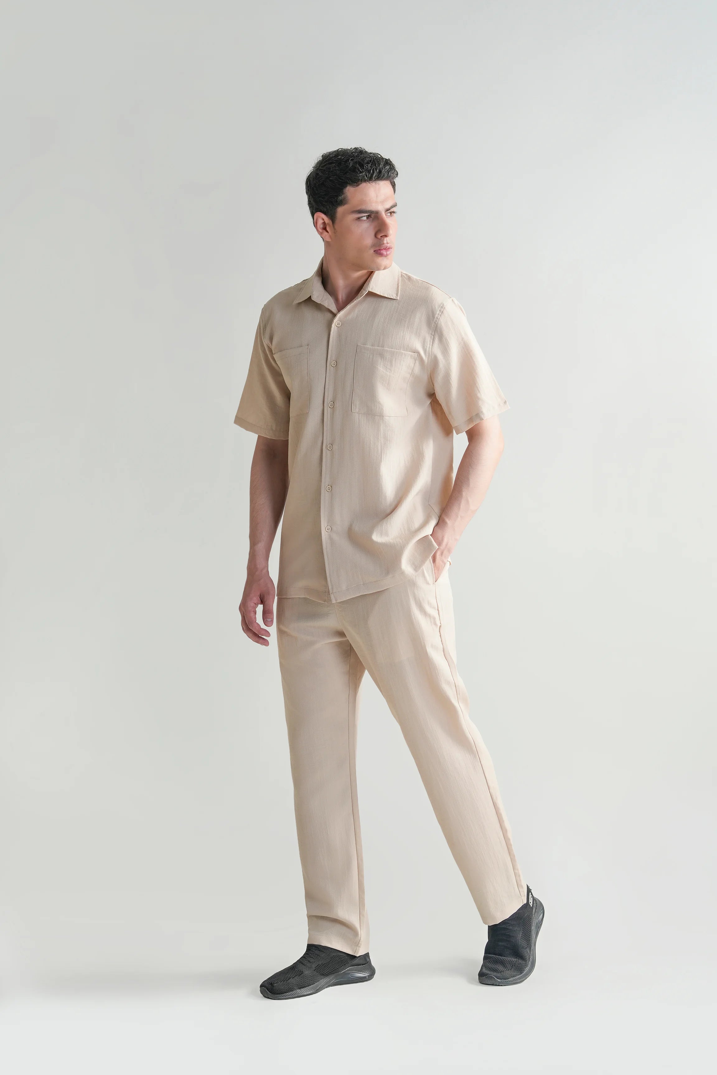 Beige short-sleeve casual shirt with regular collar and button-front, angled view