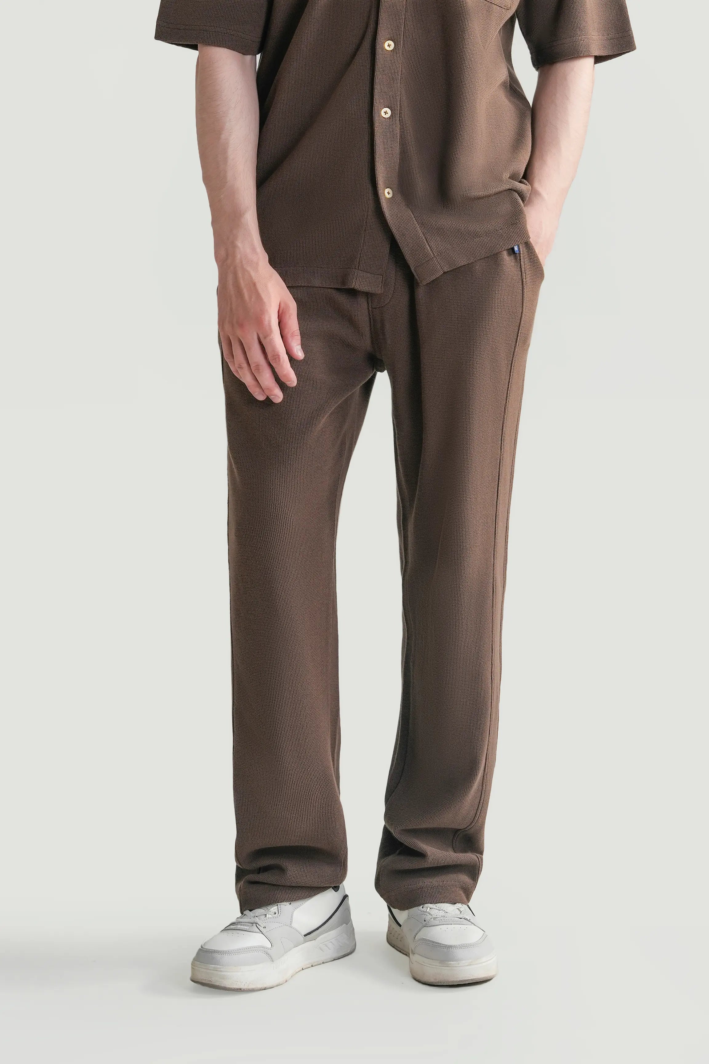 Brown loose-fit knit trousers with drawstring waist and side pockets