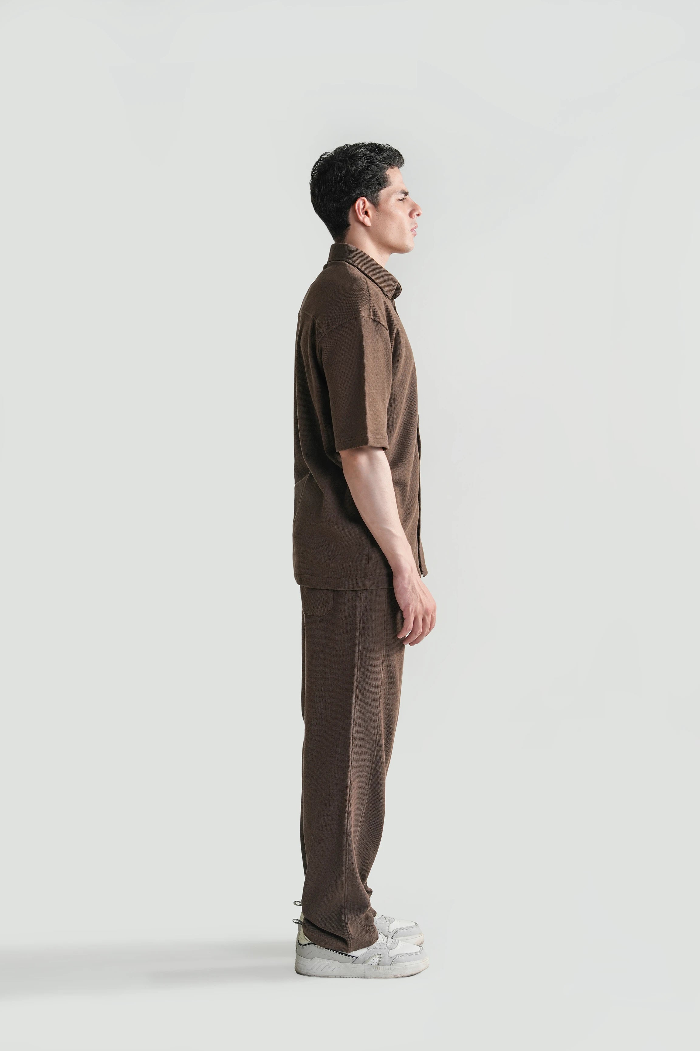 Brown knit casual shirt with short sleeves and button-front, side profile
