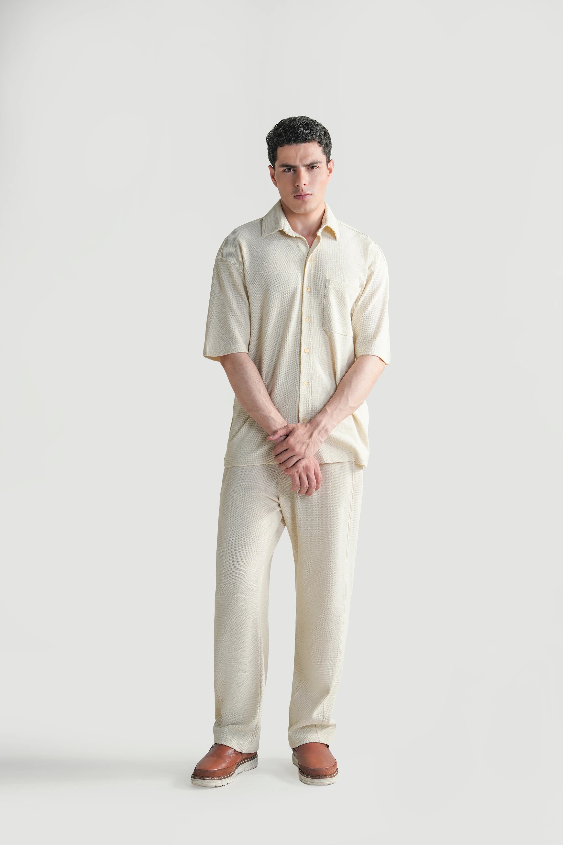 Off-white knit casual shirt with collar, short sleeves, and button-front closure