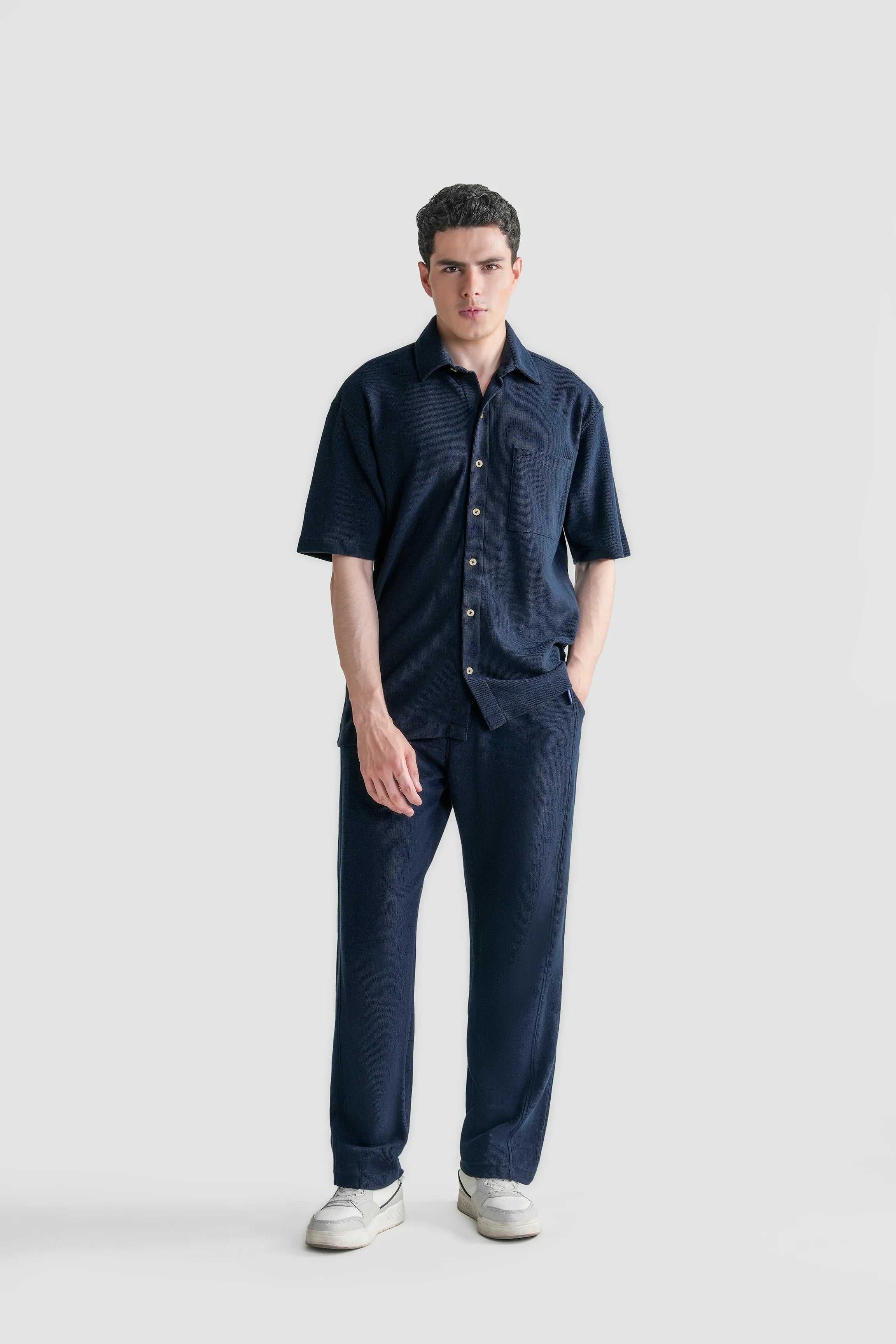 Navy short-sleeve knit button-up casual shirt with chest pocket, relaxed fit.