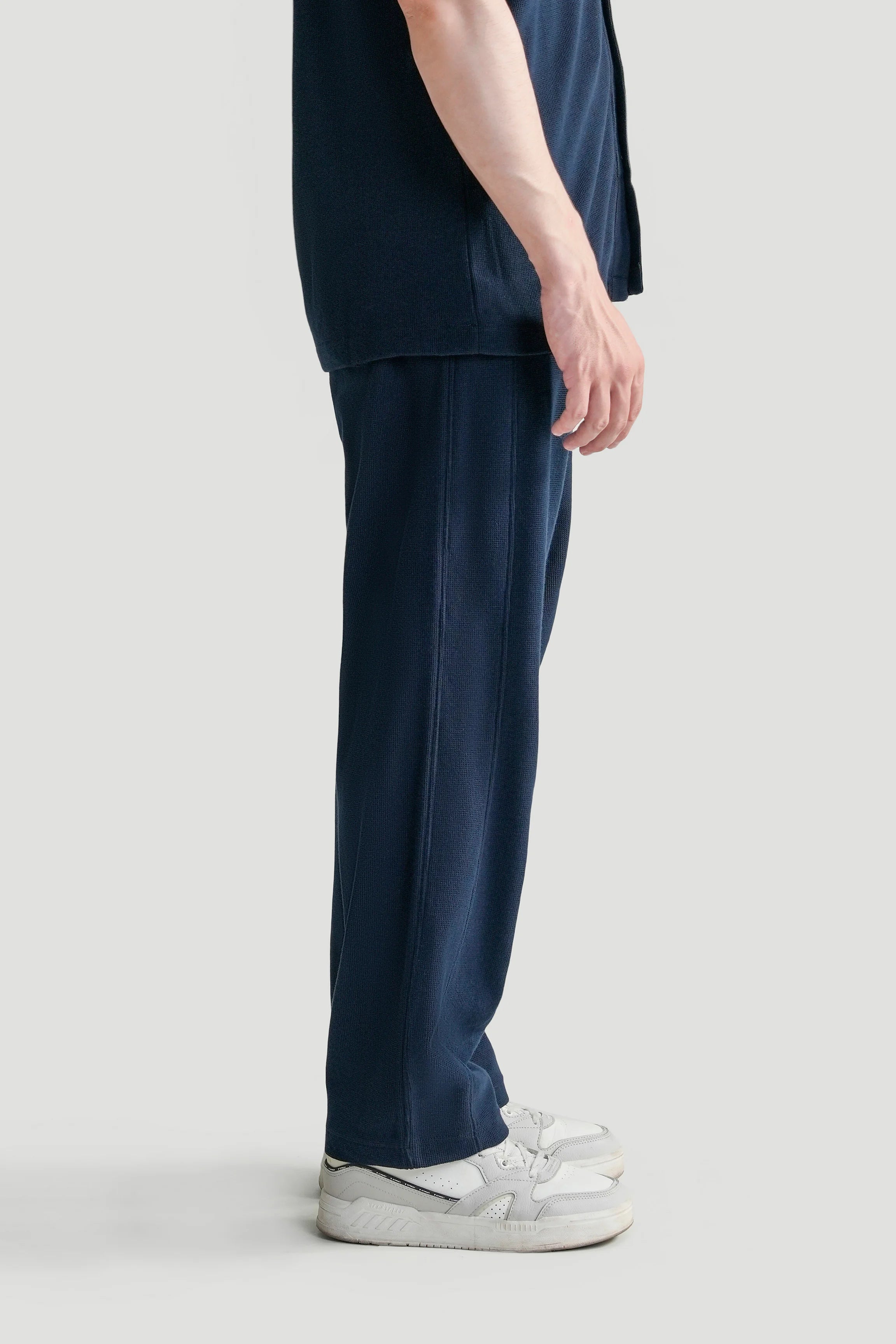 Navy knit trousers with relaxed straight leg and side seam panel