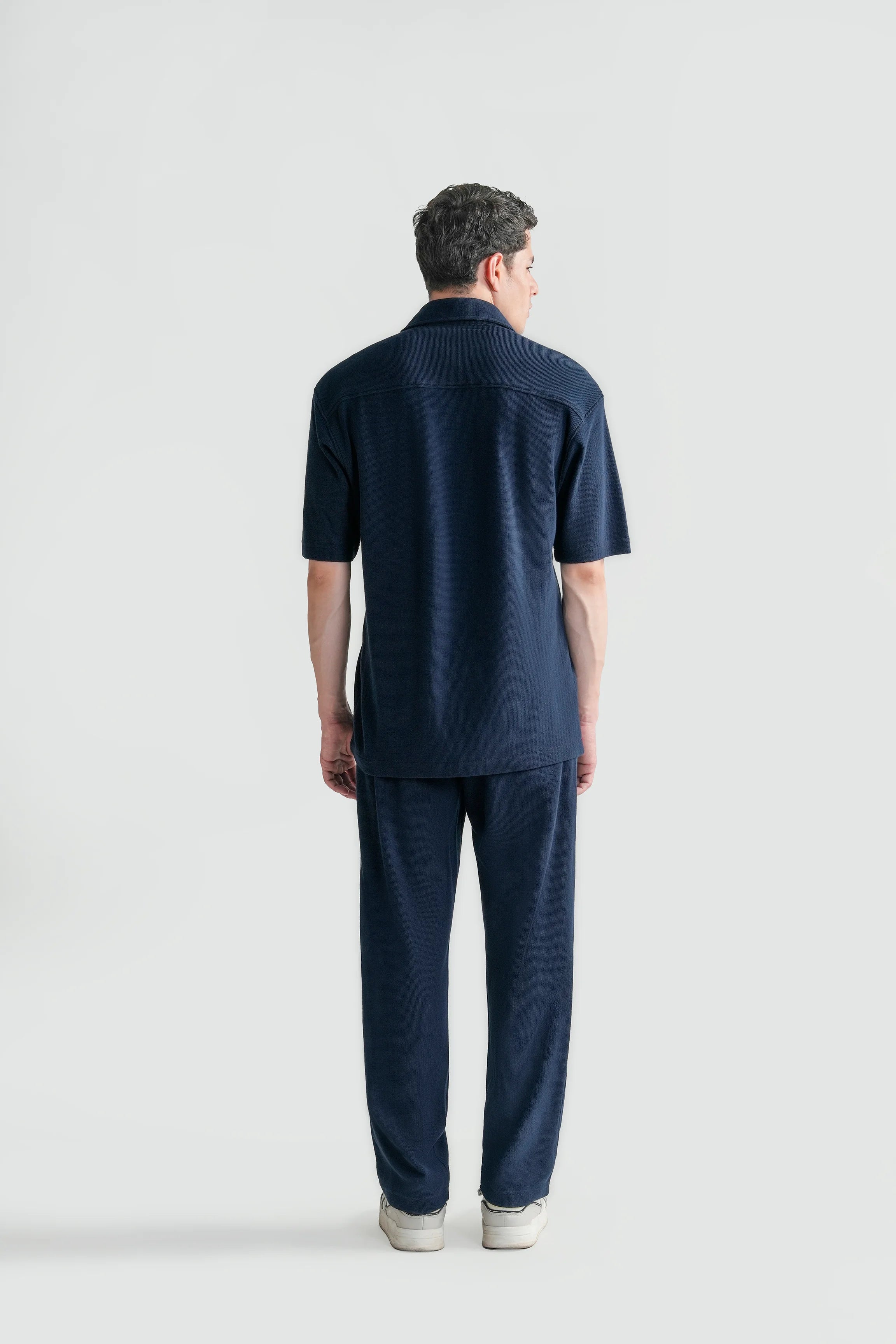 Navy short-sleeve knit button-up casual shirt, back view, relaxed fit.