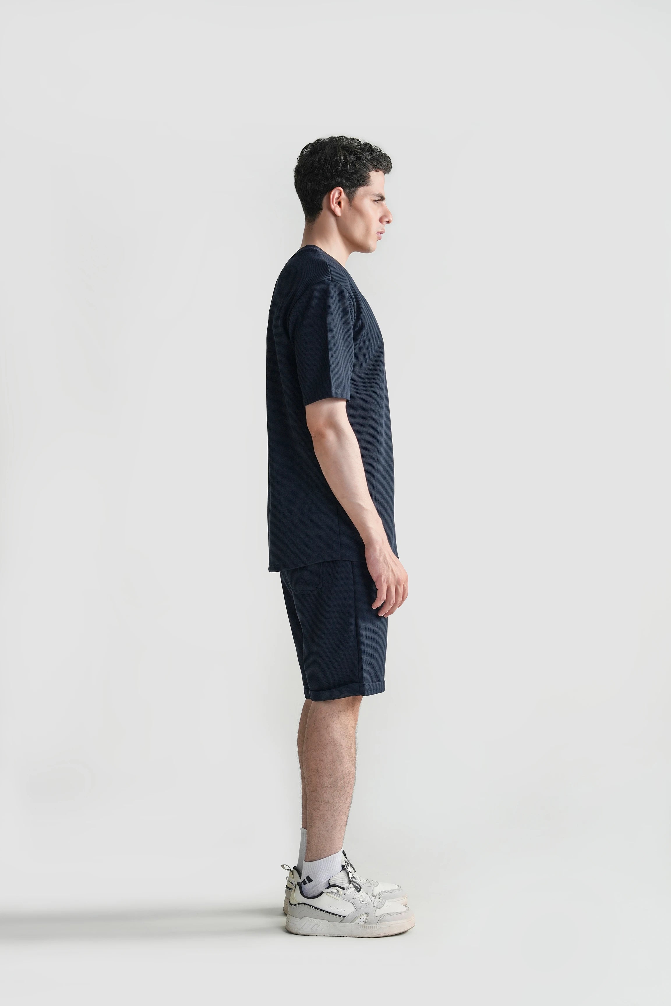 Navy oversized crew neck T-shirt, side view showing relaxed drape and hem length