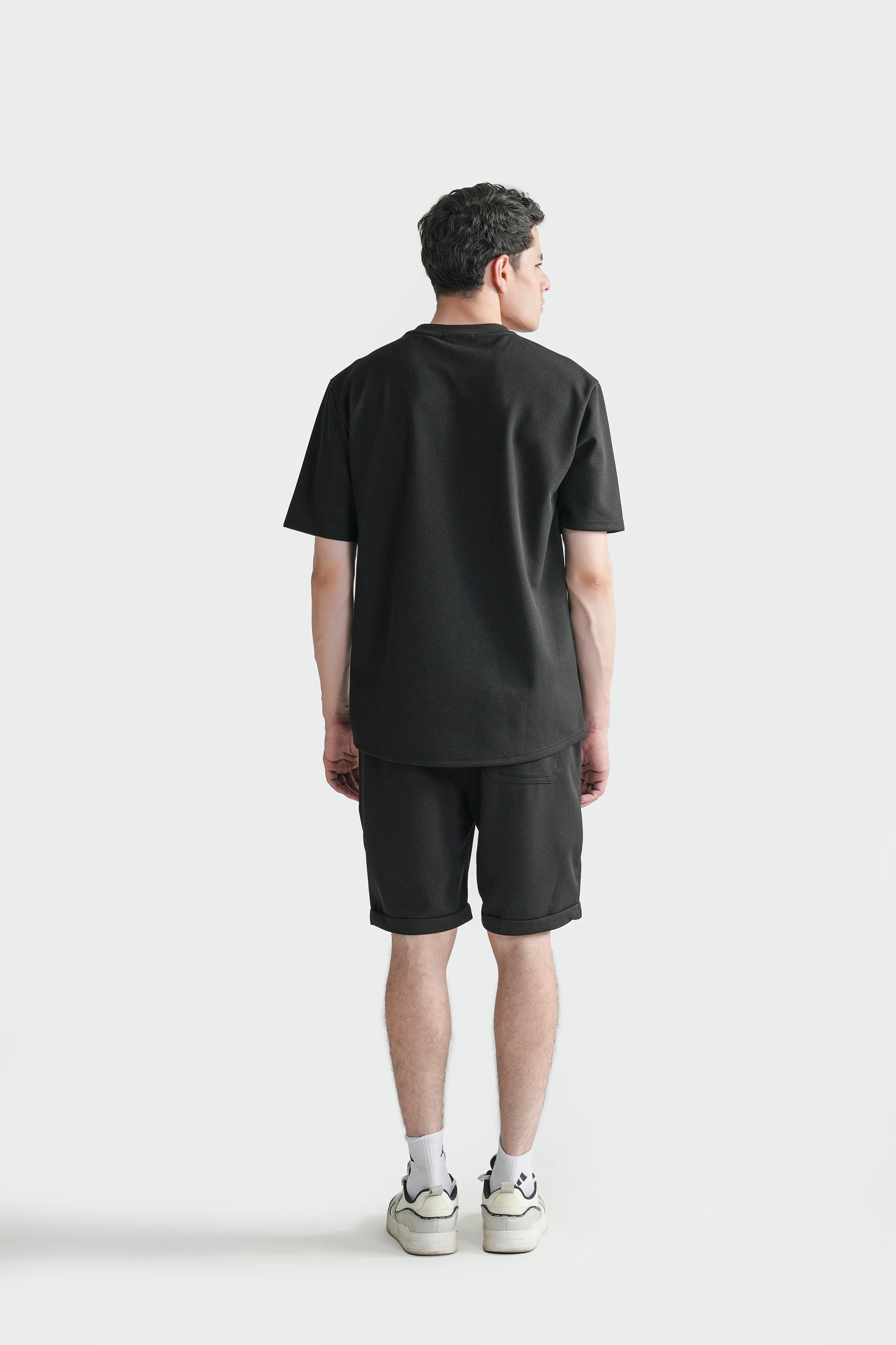 Oversize crew neck T-shirt in black, back view with short sleeves and straight hem