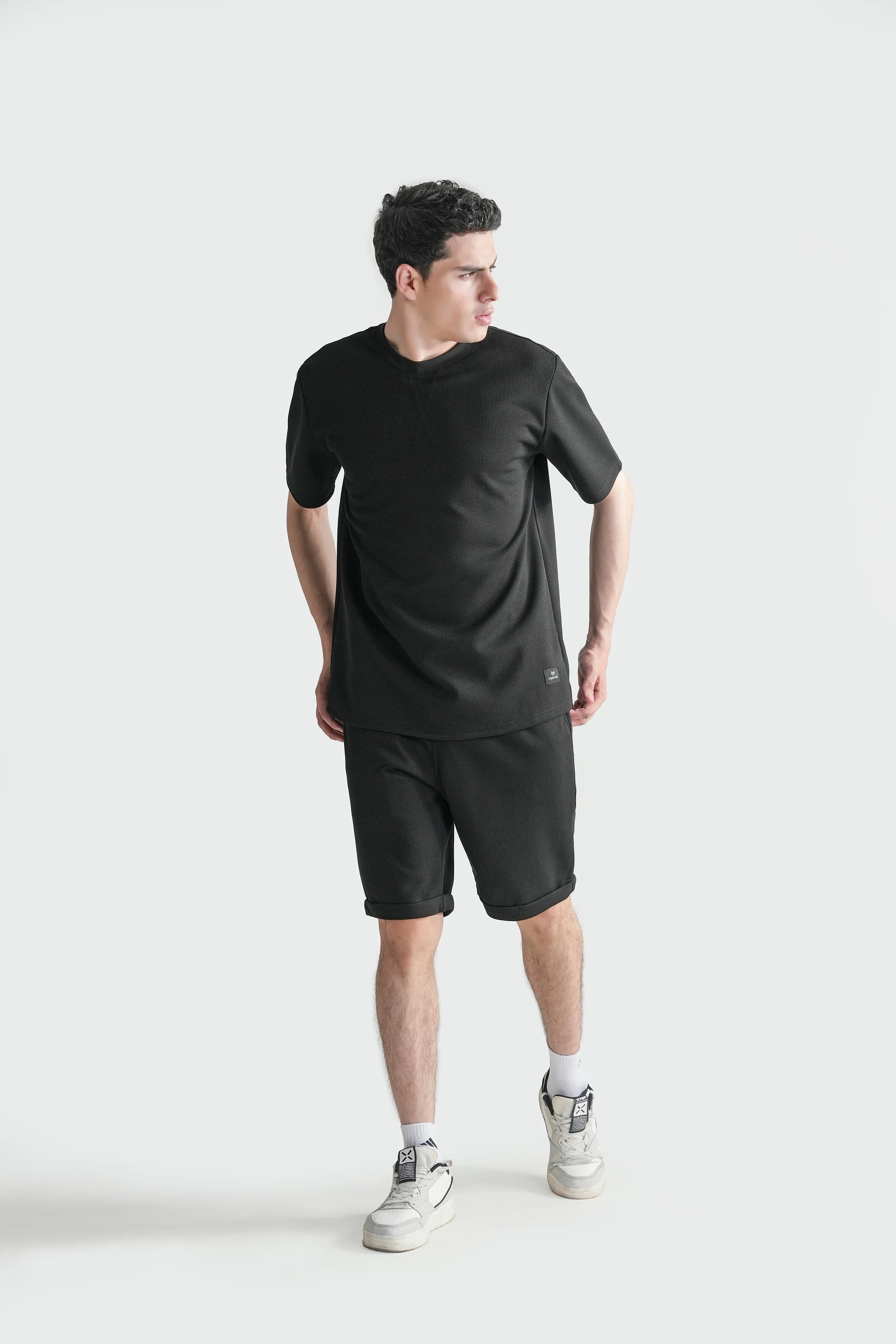 Oversize crew neck T-shirt in black, front three-quarter view with relaxed fit