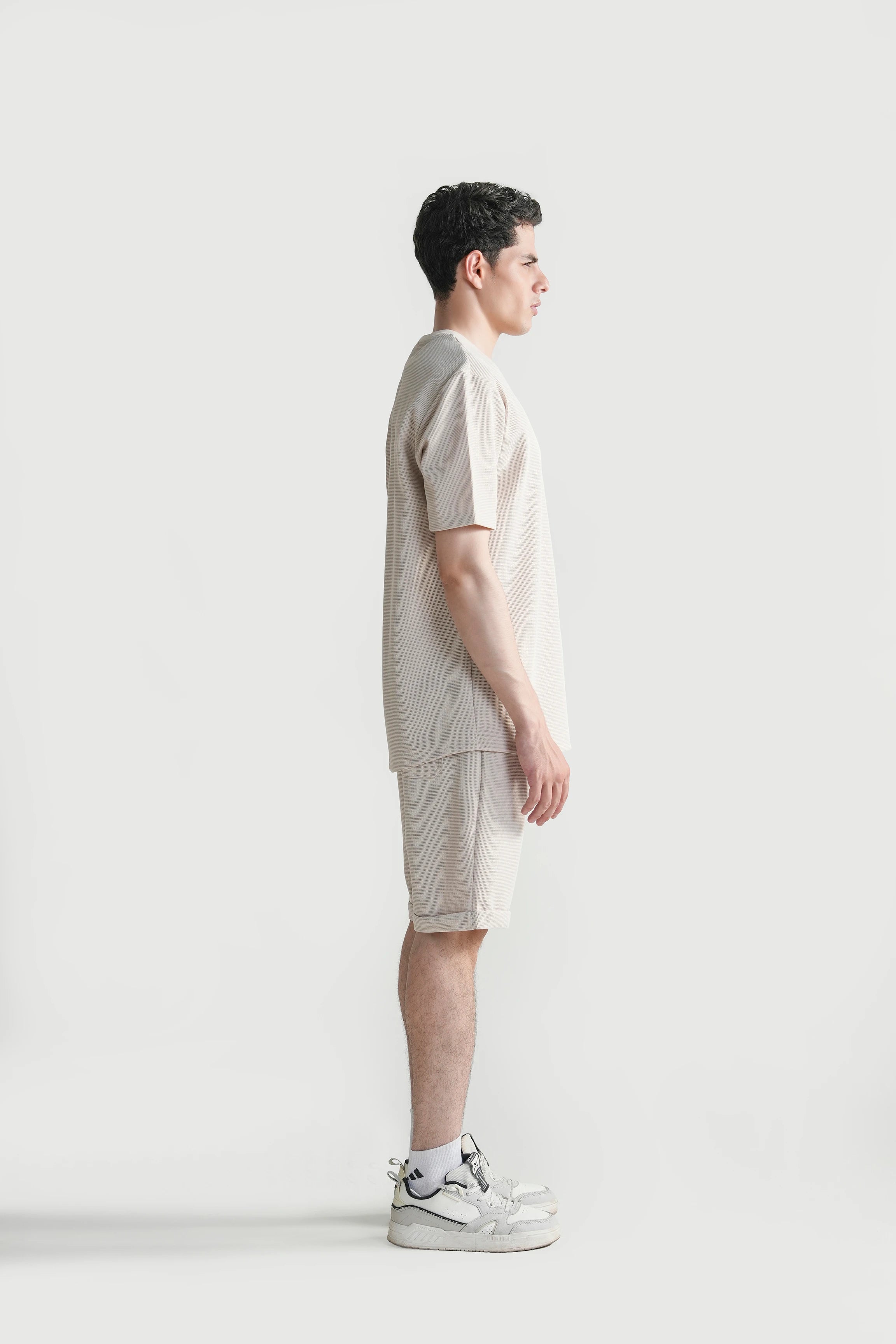 Beige oversized crew neck T-shirt, side view, relaxed short-sleeve fit