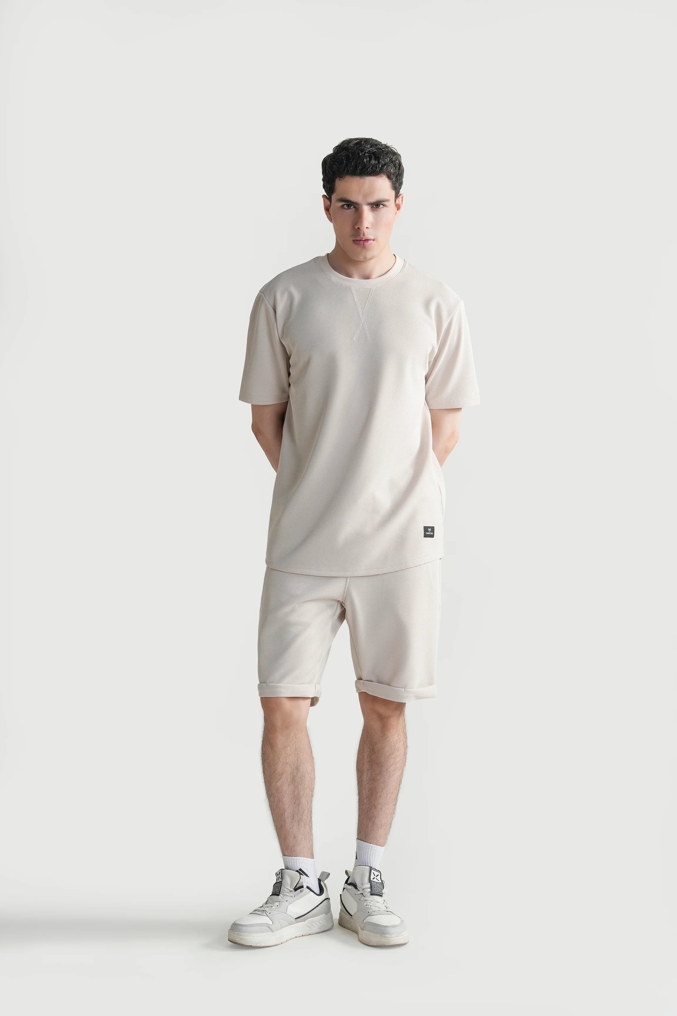 Beige oversized crew neck T-shirt with small chest logo patch