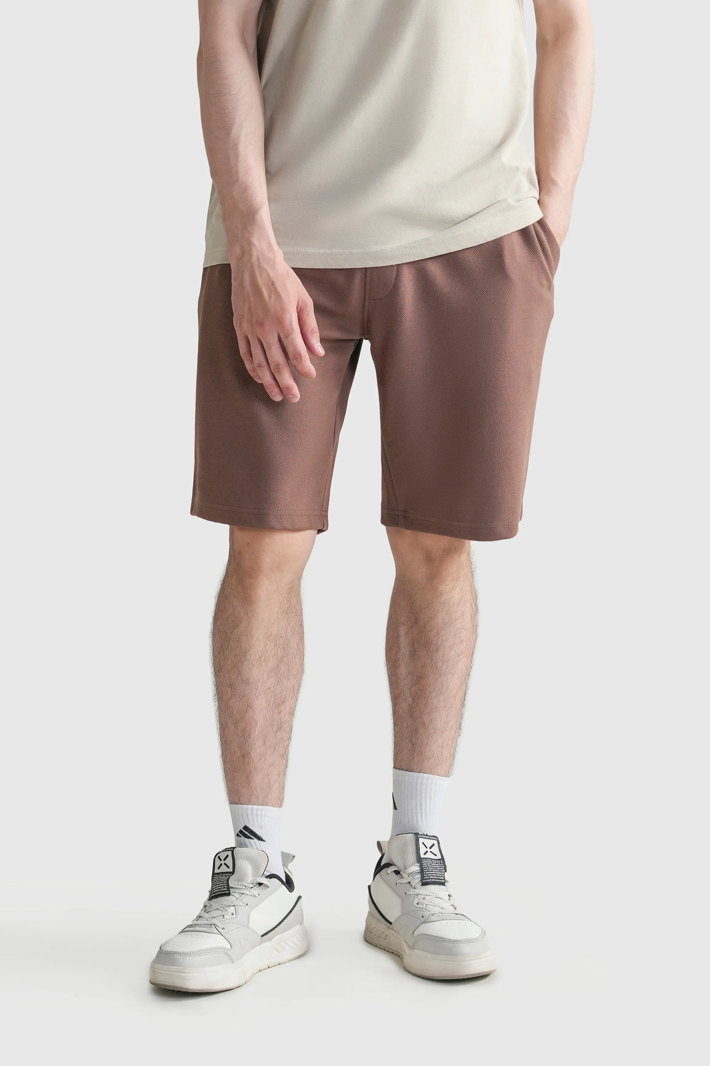 Men's regular-fit rust-brown shorts with elastic waistband and mid-thigh length.