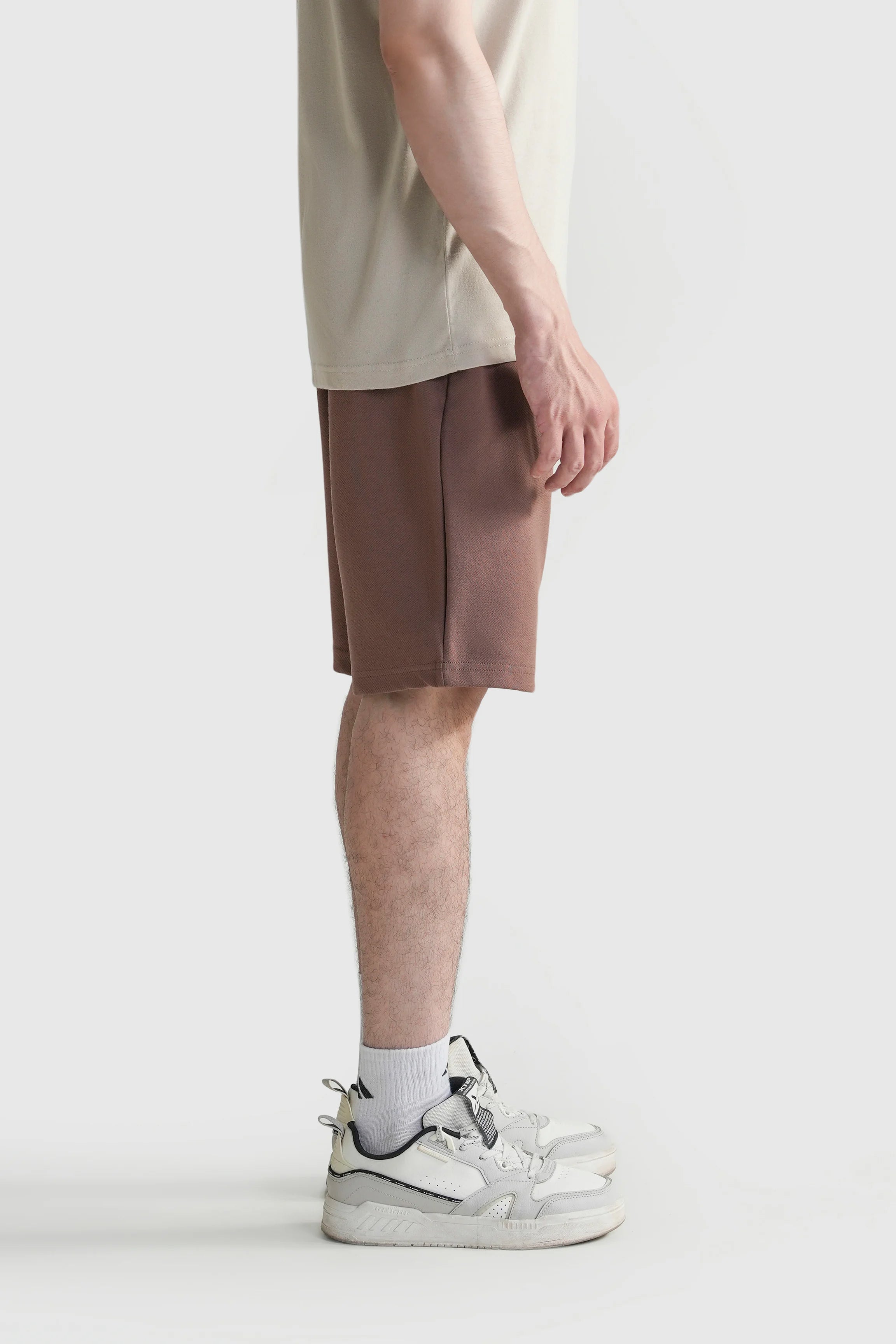 Men's regular-fit rust-brown shorts with elastic waistband, side view.