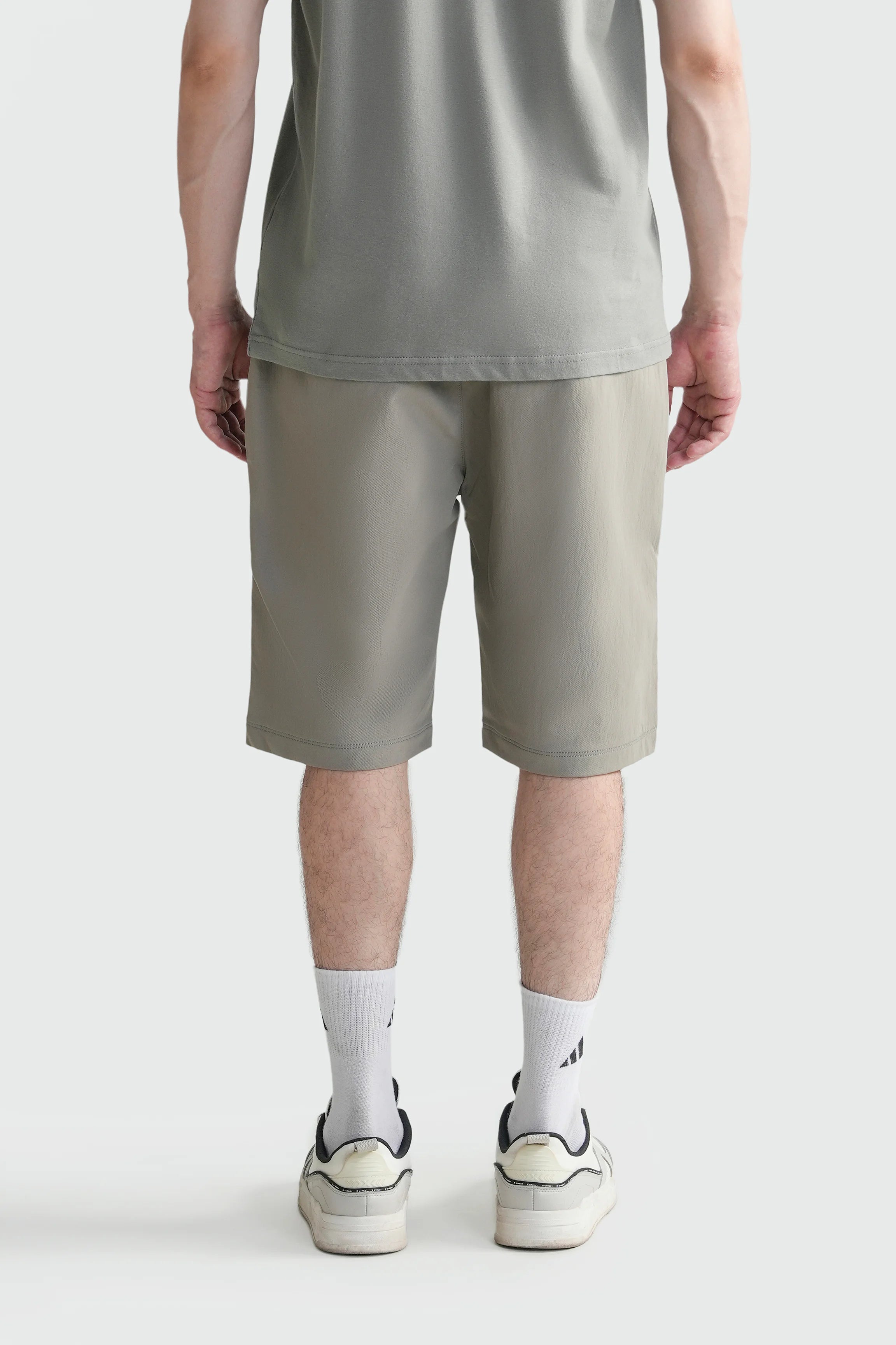 Olive regular-fit shorts with elastic waistband and straight knee-length legs.