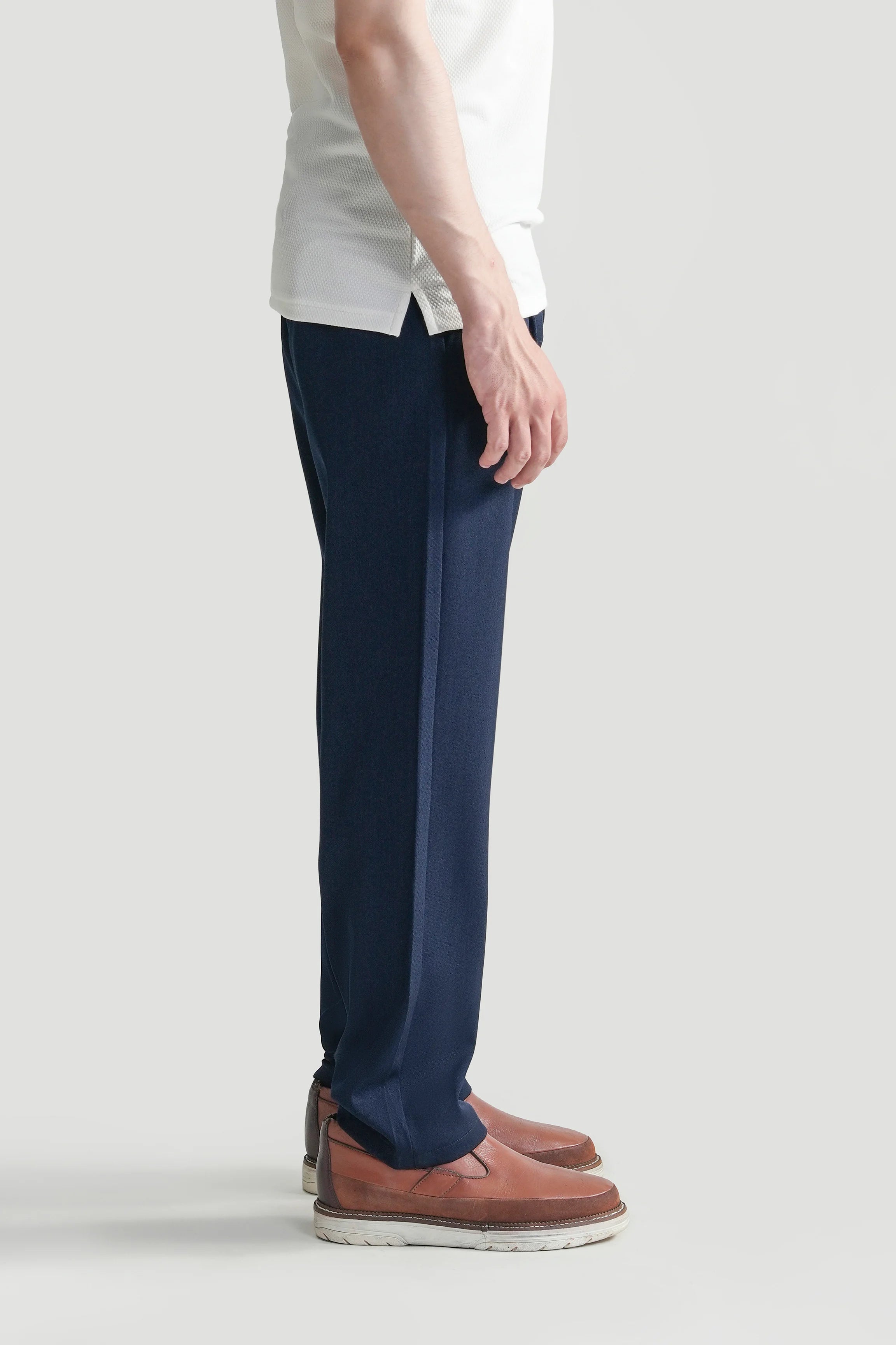 Blue straight-leg casual pants, side view with front crease and button closure