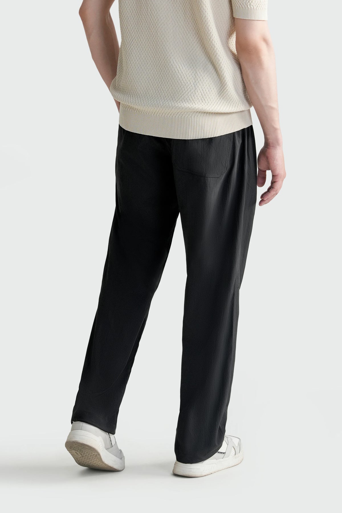 Black relaxed-fit trousers with draped wide legs and side pockets