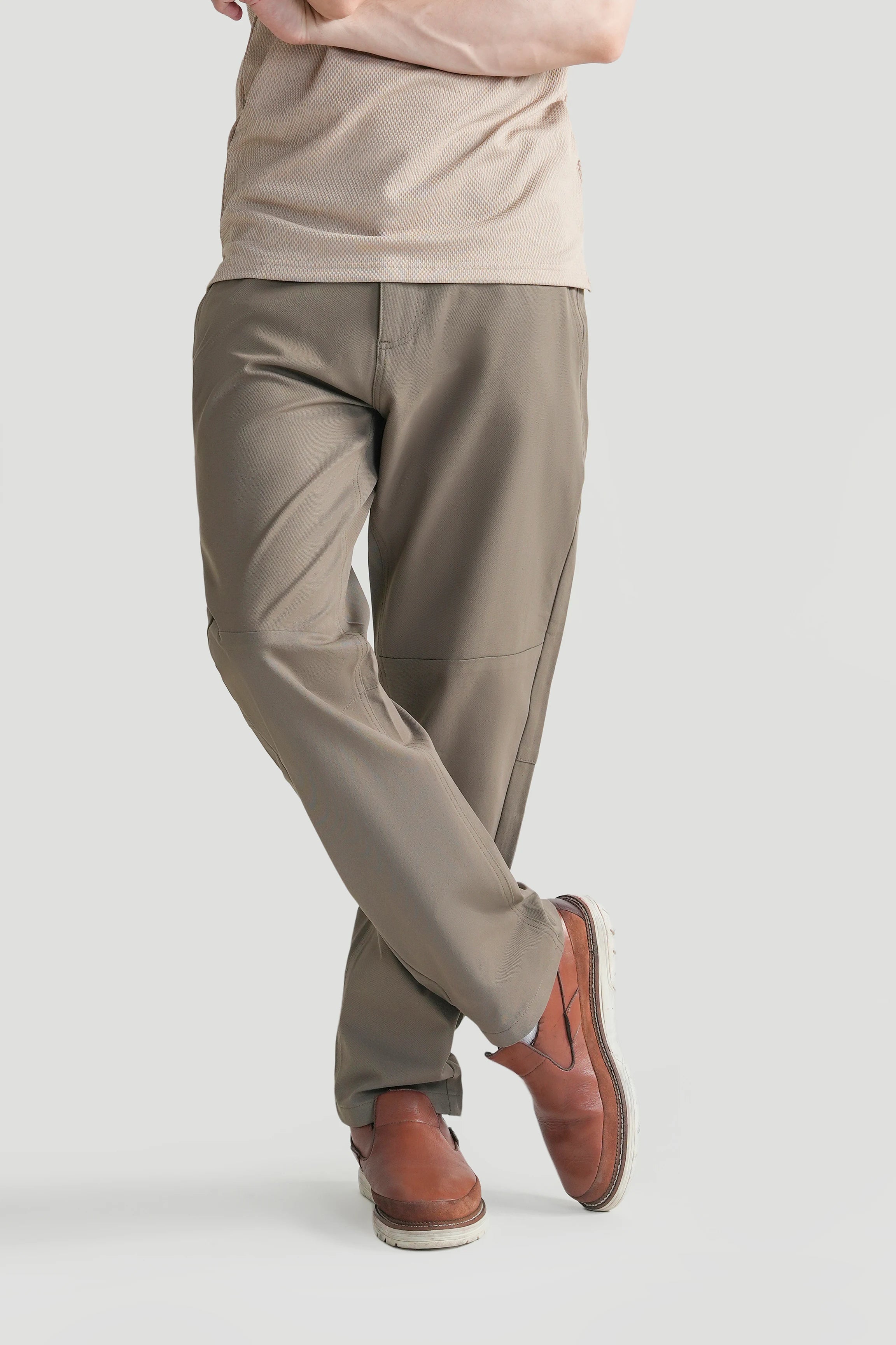 Straight-fit travel pants in light brown, angled side view with zip fly and cuff detail.