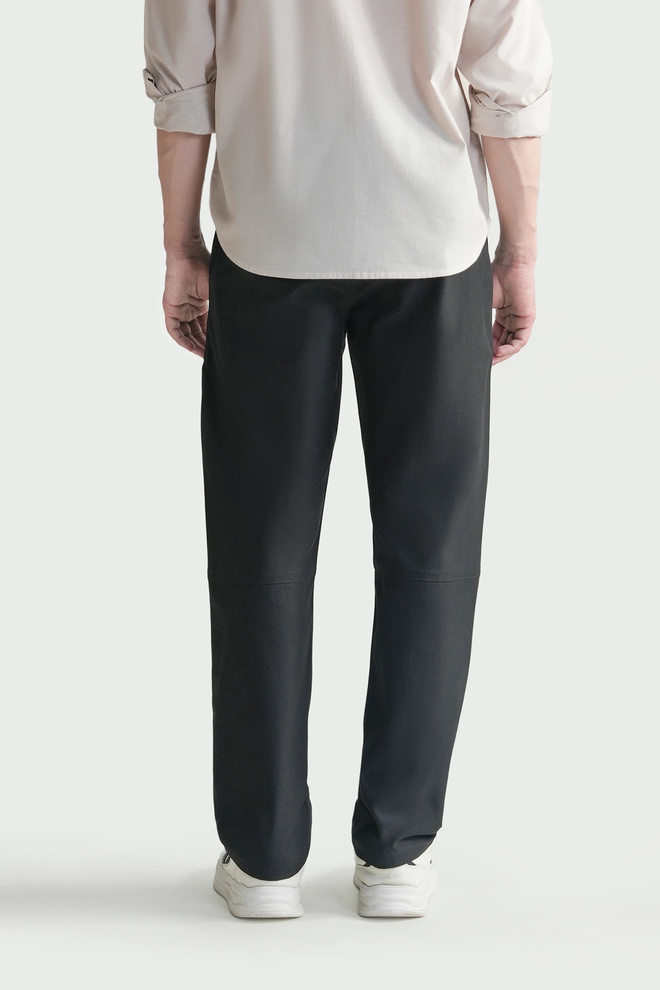 Black straight-fit travel pants with straight leg and button closure; belt loops on waistband