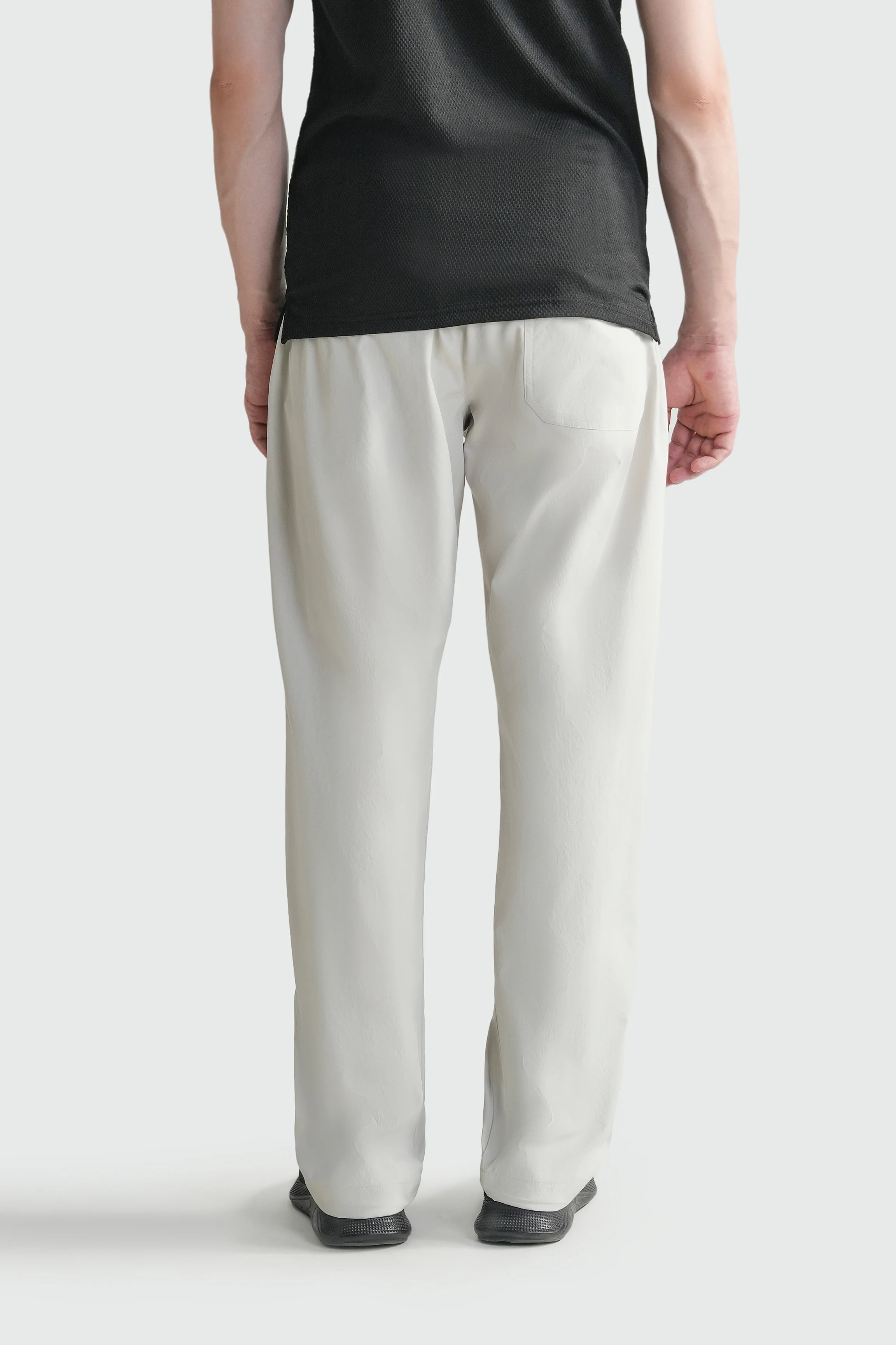 Stone loose-fit casual trousers shown from front with elastic waist and relaxed legs