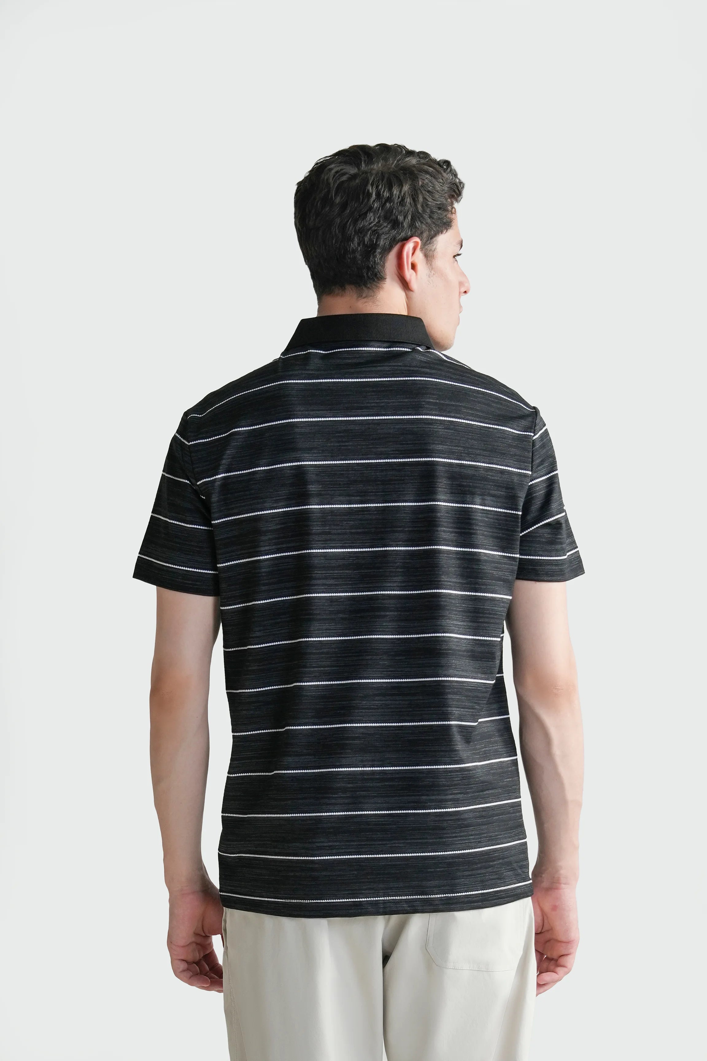 Men's black striped polo shirt shown from the back with short sleeves