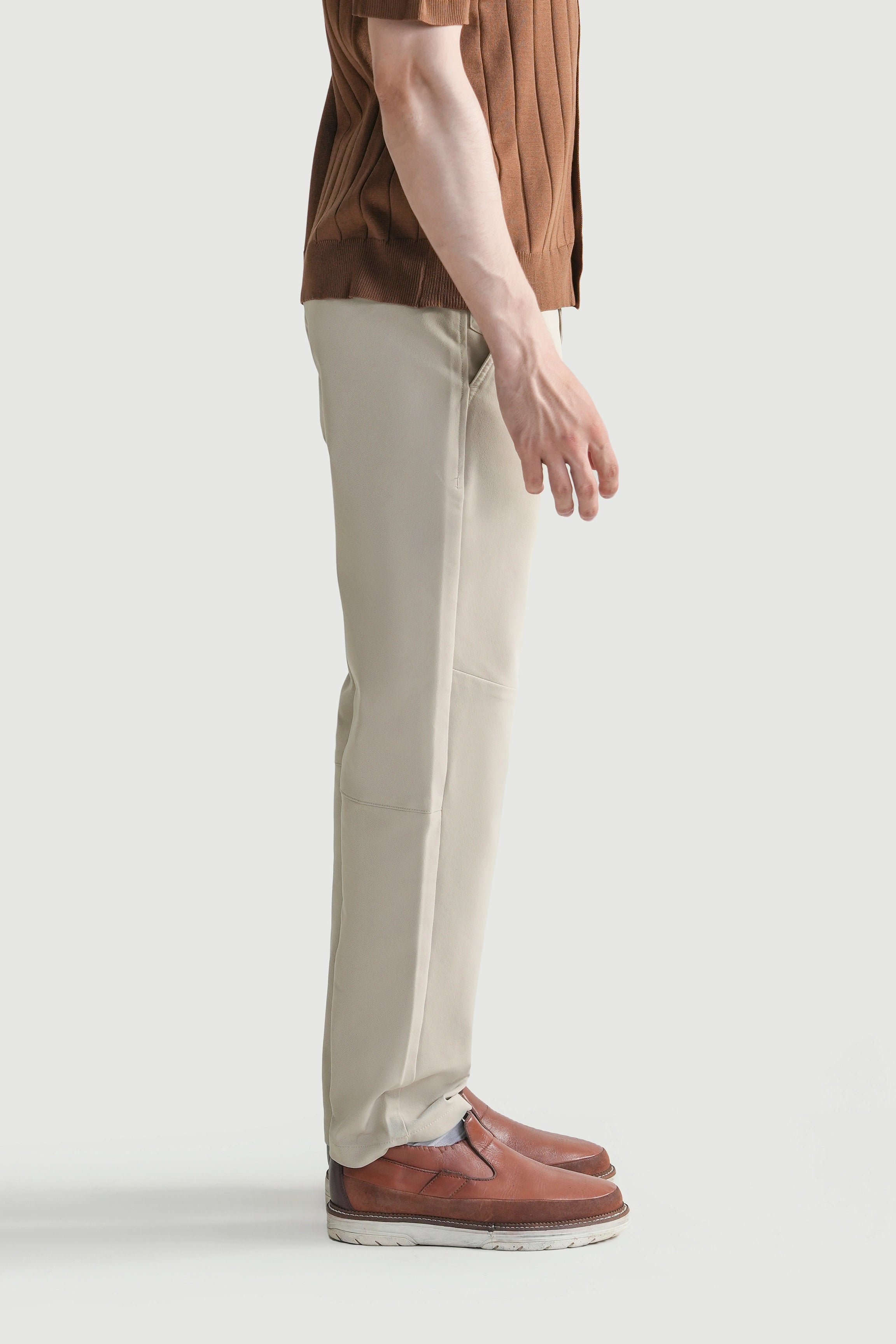 Light beige straight-fit travel pants, side view with belt loops and front pockets