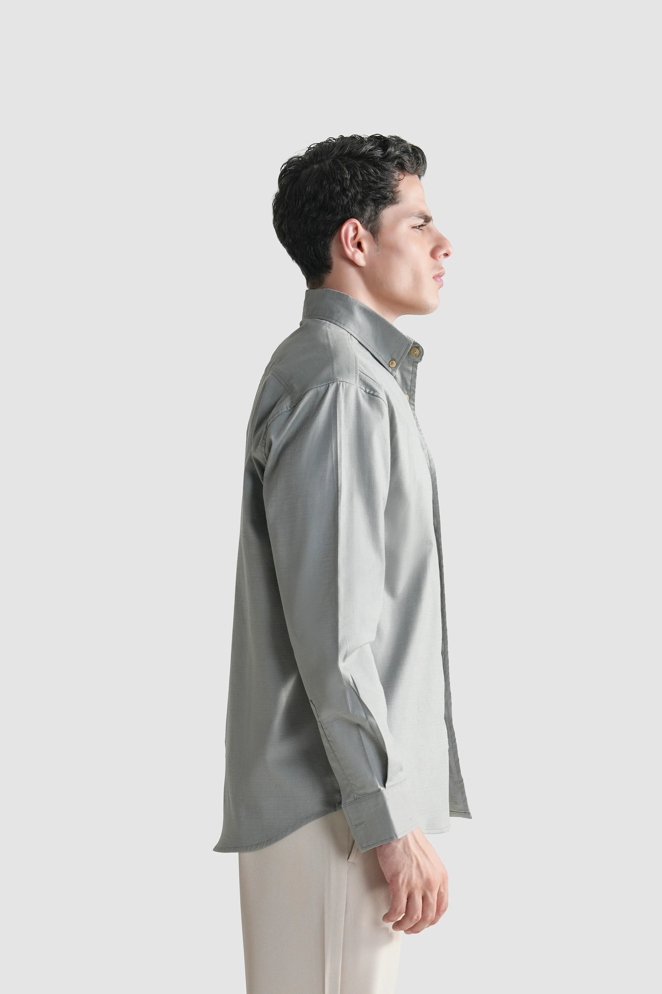 Grey button-down casual shirt side view with long sleeves and collar.