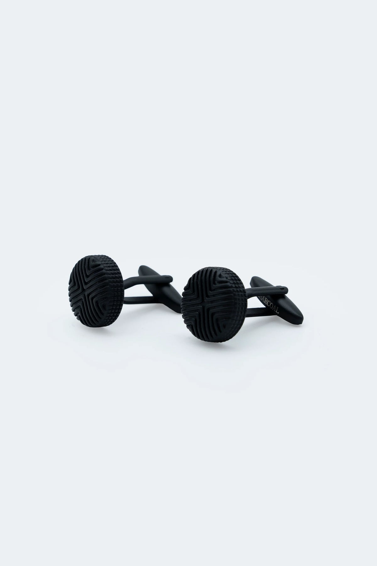 Pair of dark round cufflinks with textured faces and bar clasps