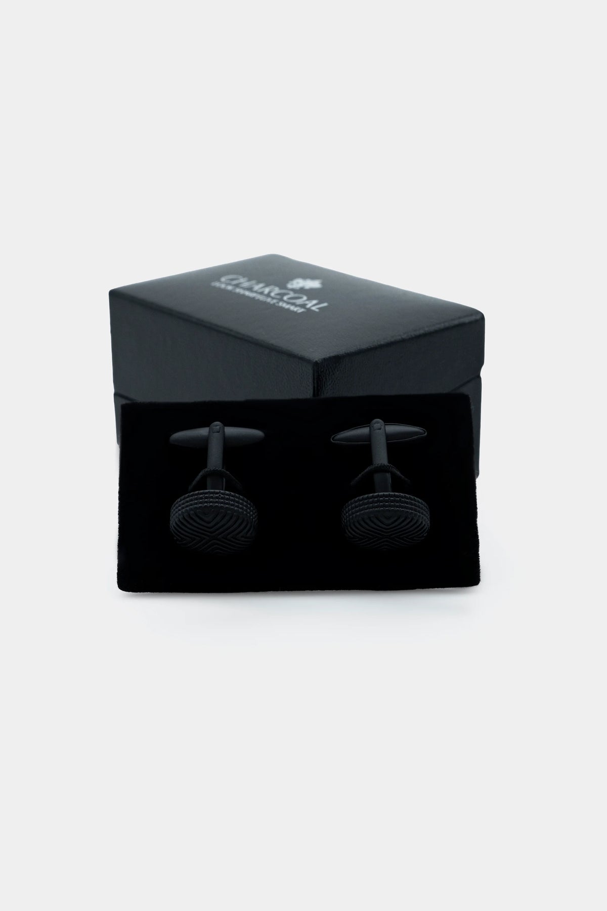 Cufflinks in black gift box with textured round faces