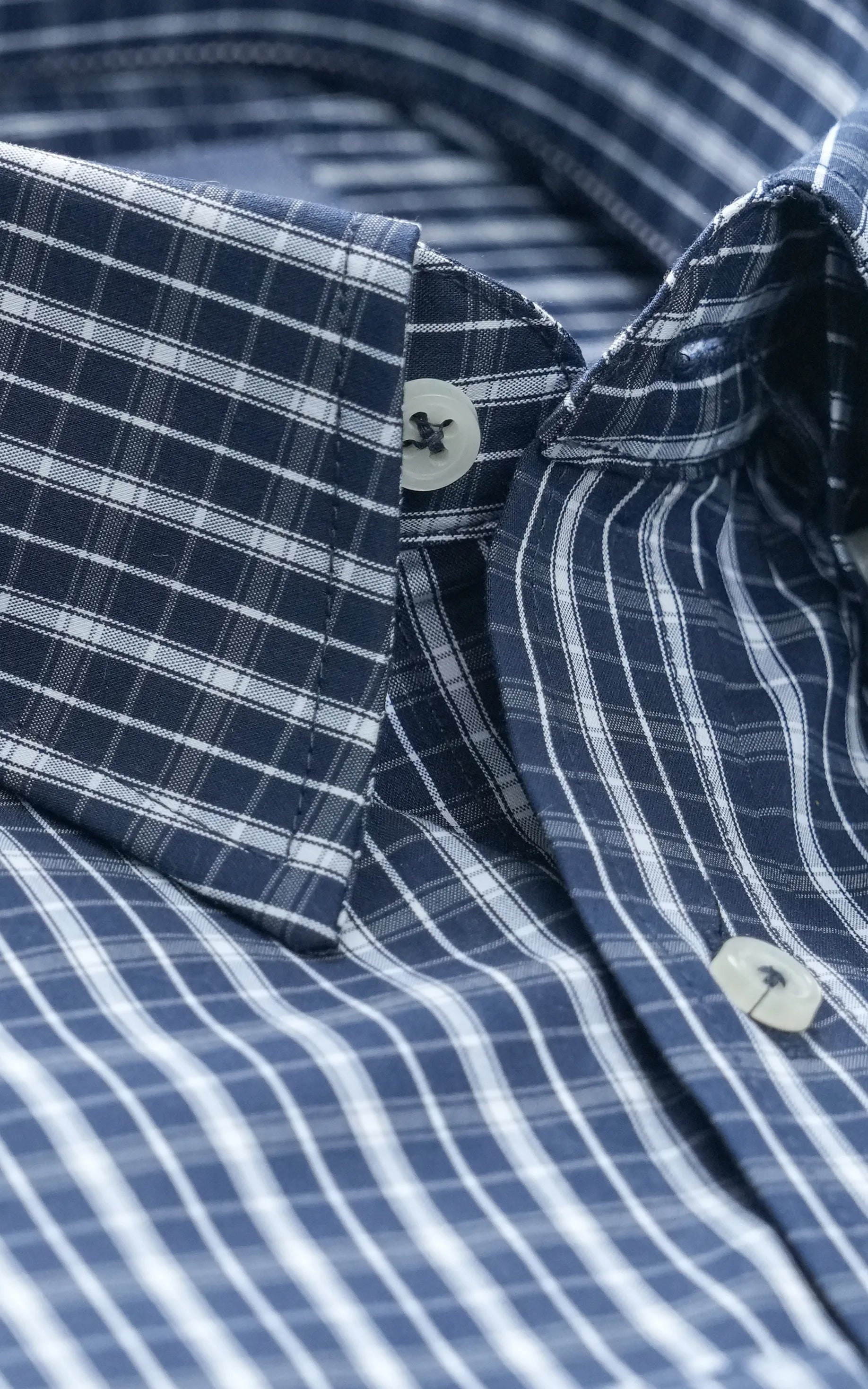 Navy check dress shirt with button placket and textured fabric weave detail