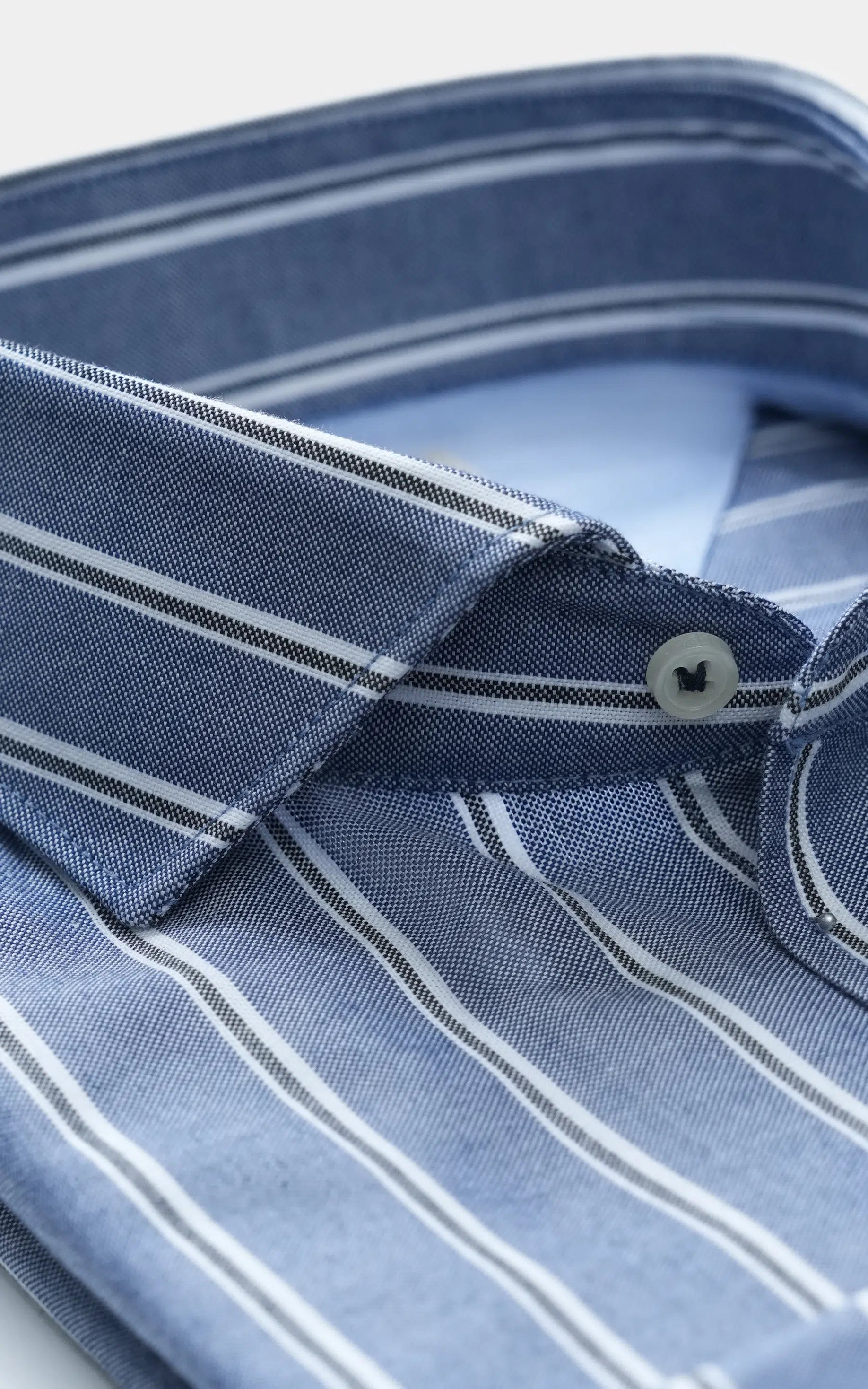 Chambray blue striped French collar shirt close-up with buttoned placket