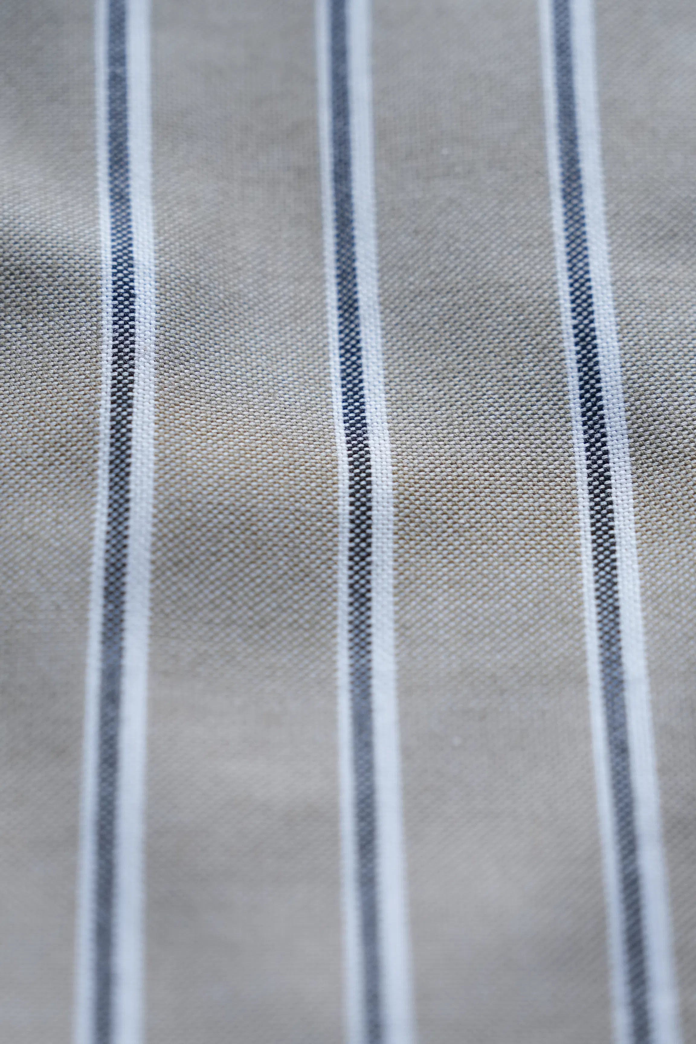 Light green fabric with blue vertical stripe pattern, close-up